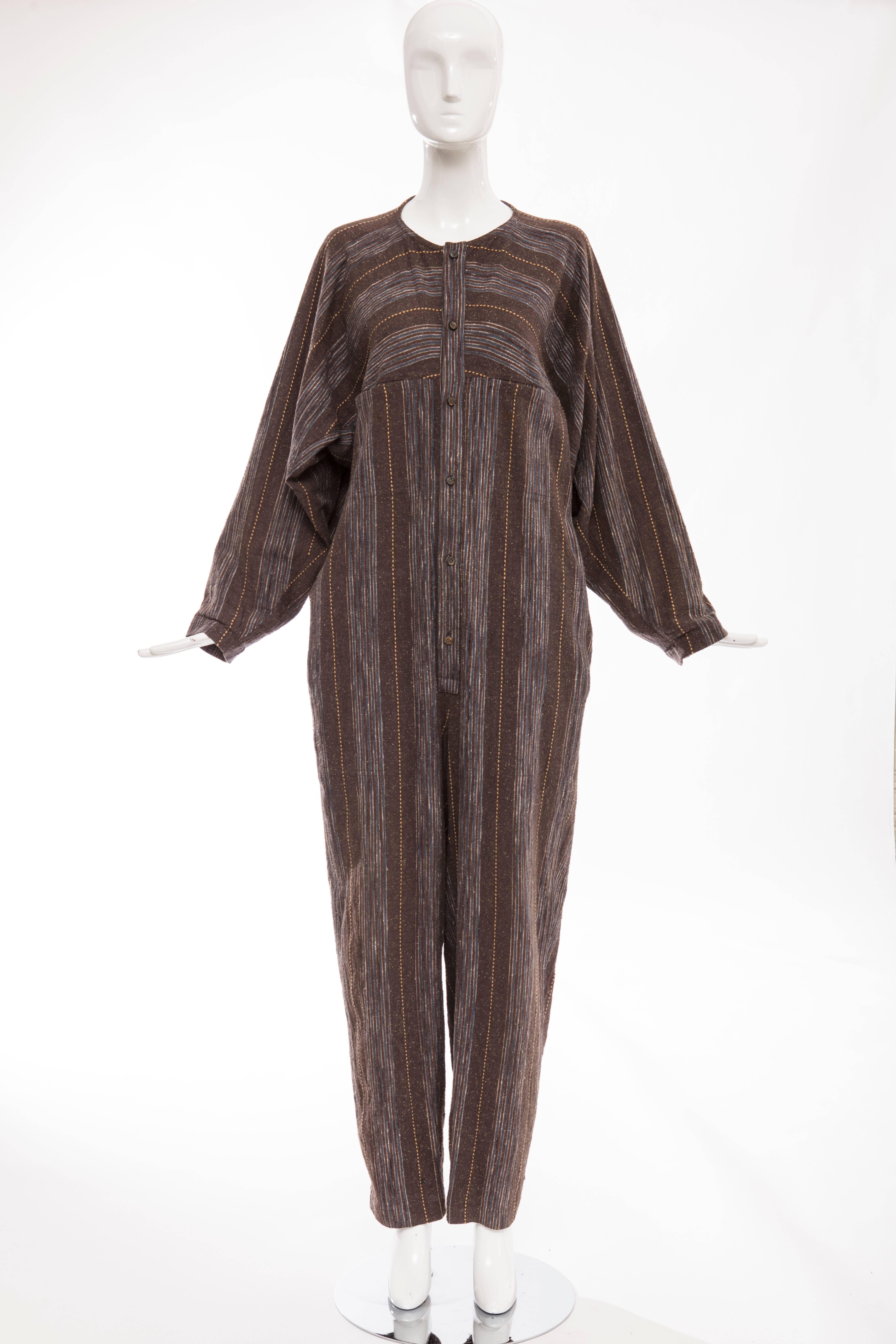 Issey Miyake Plantation, circa 1980's blue chocolate brown striped woven medium weight cotton jumpsuit with front wood button closure and two front pockets.

Japan: Medium

Bust 54