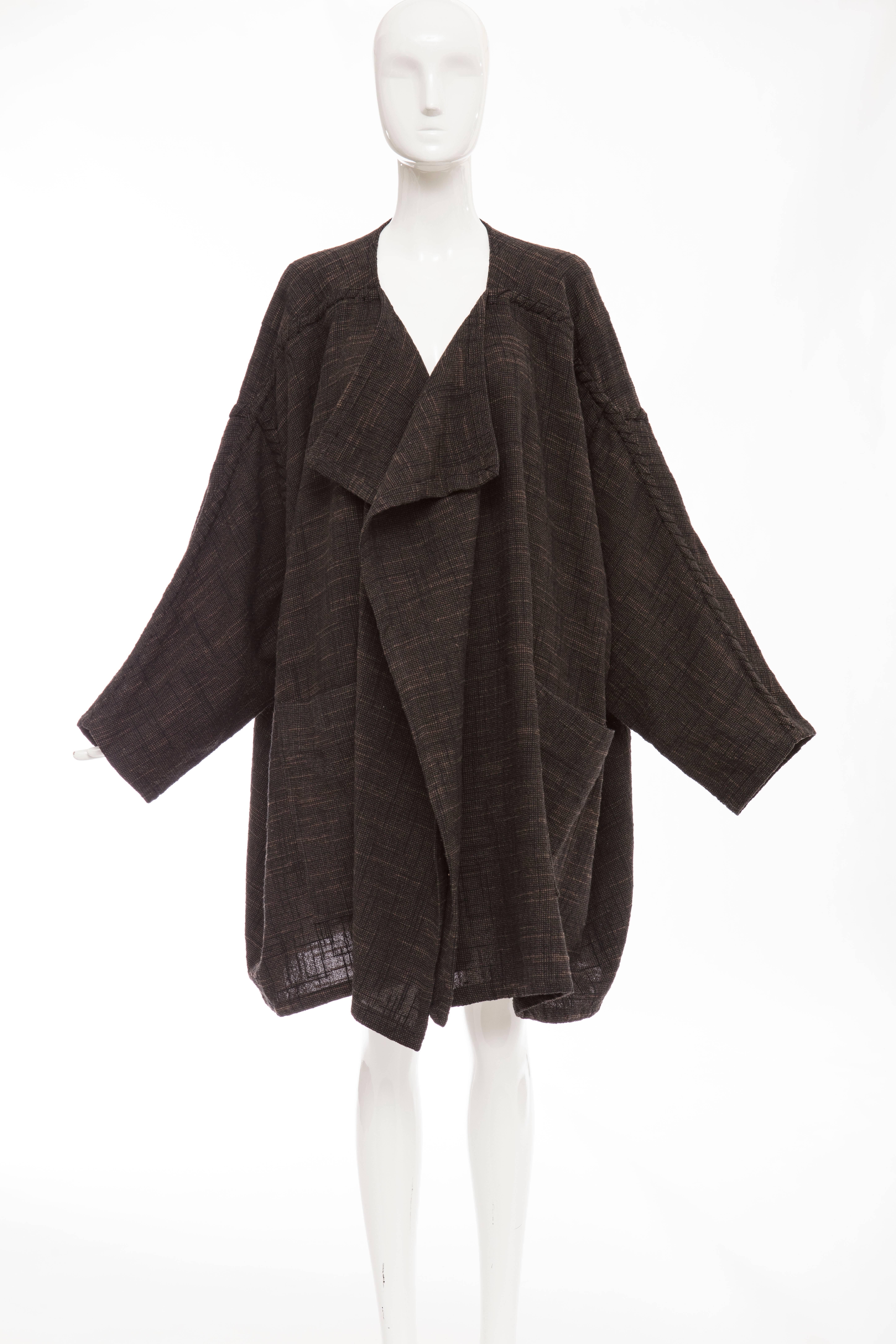 Issey Miyake Plantation, circa 1980's wool cotton nylon woven navy blue brown oversized draped jacket, shoulder sleeve black cording detail with two large deep patch front pockets.

Japan: Medium

Bust 76, Waist 76, Hips 76, Length 36