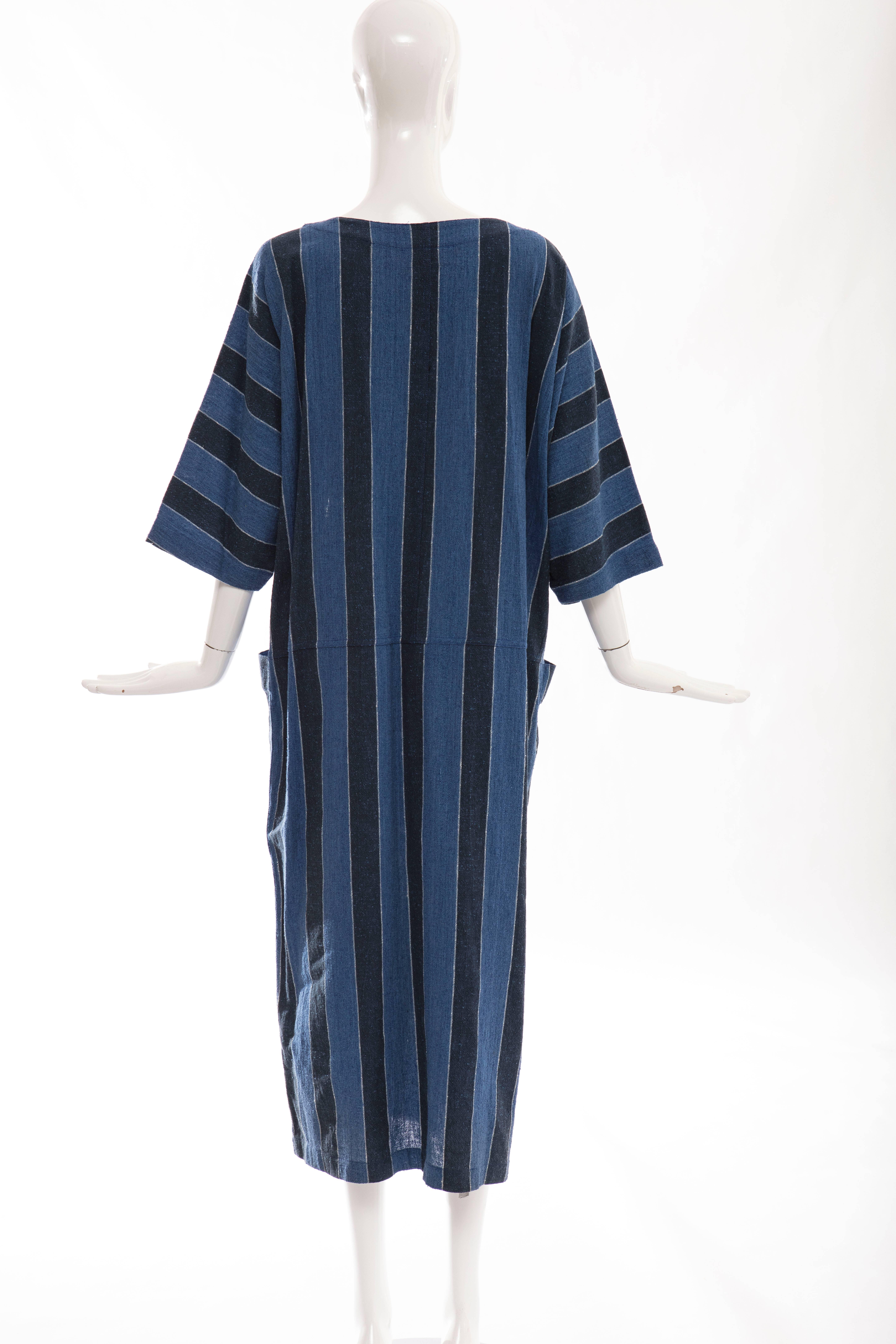 issey Miyake Plantation, circa 1980's blue striped woven cotton dress with boat neck and two deep front pockets.

Japan: Medium

Bust 48, Waist 44, Hips 44, Length 49