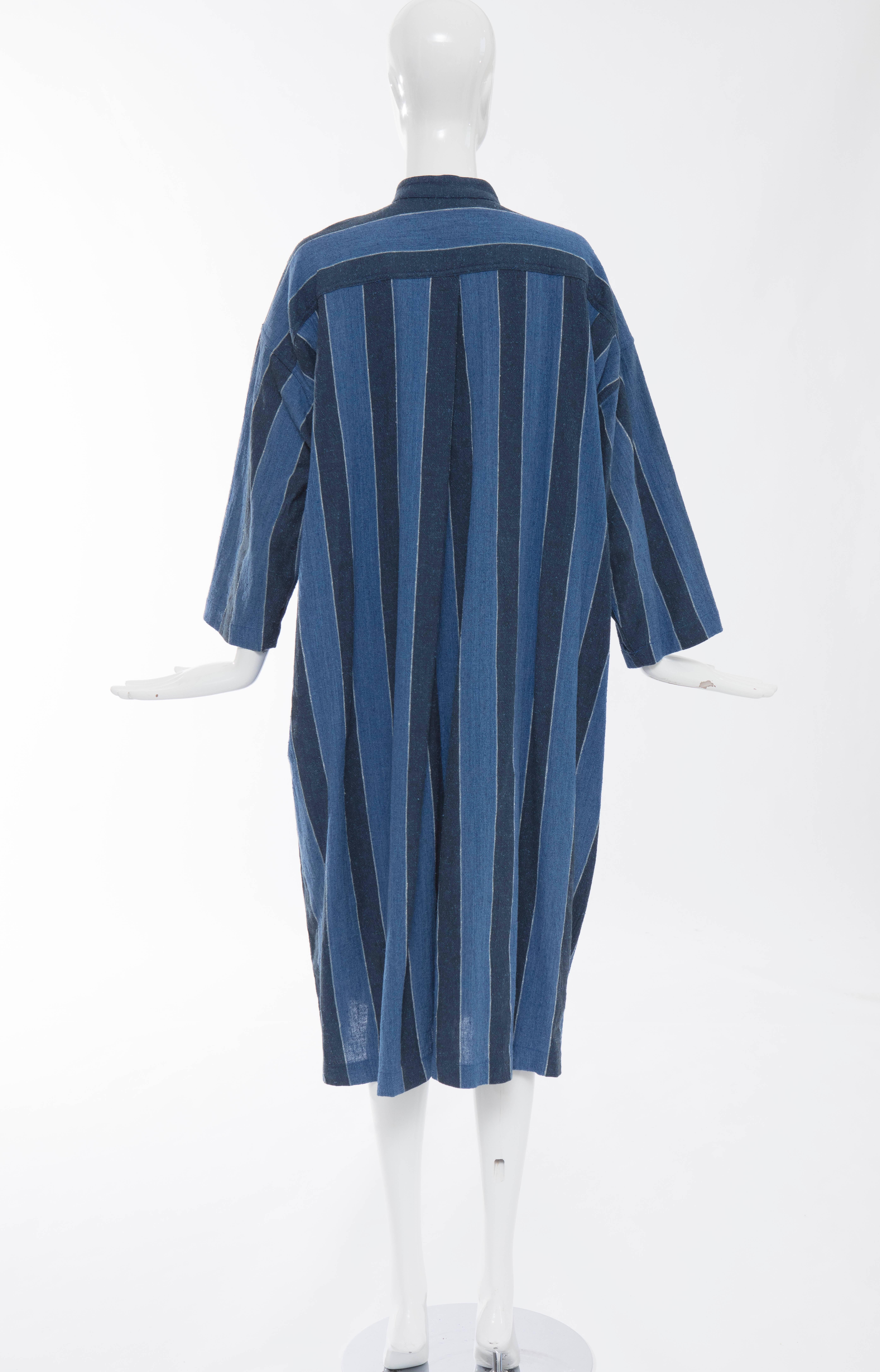 Issey Miyake Plantation, circa 1980's blue striped button front woven cotton dress with three front pockets.

Japan: Small

Bust 52, Waist 50, Hips 50, Length 46, Sleeve 16