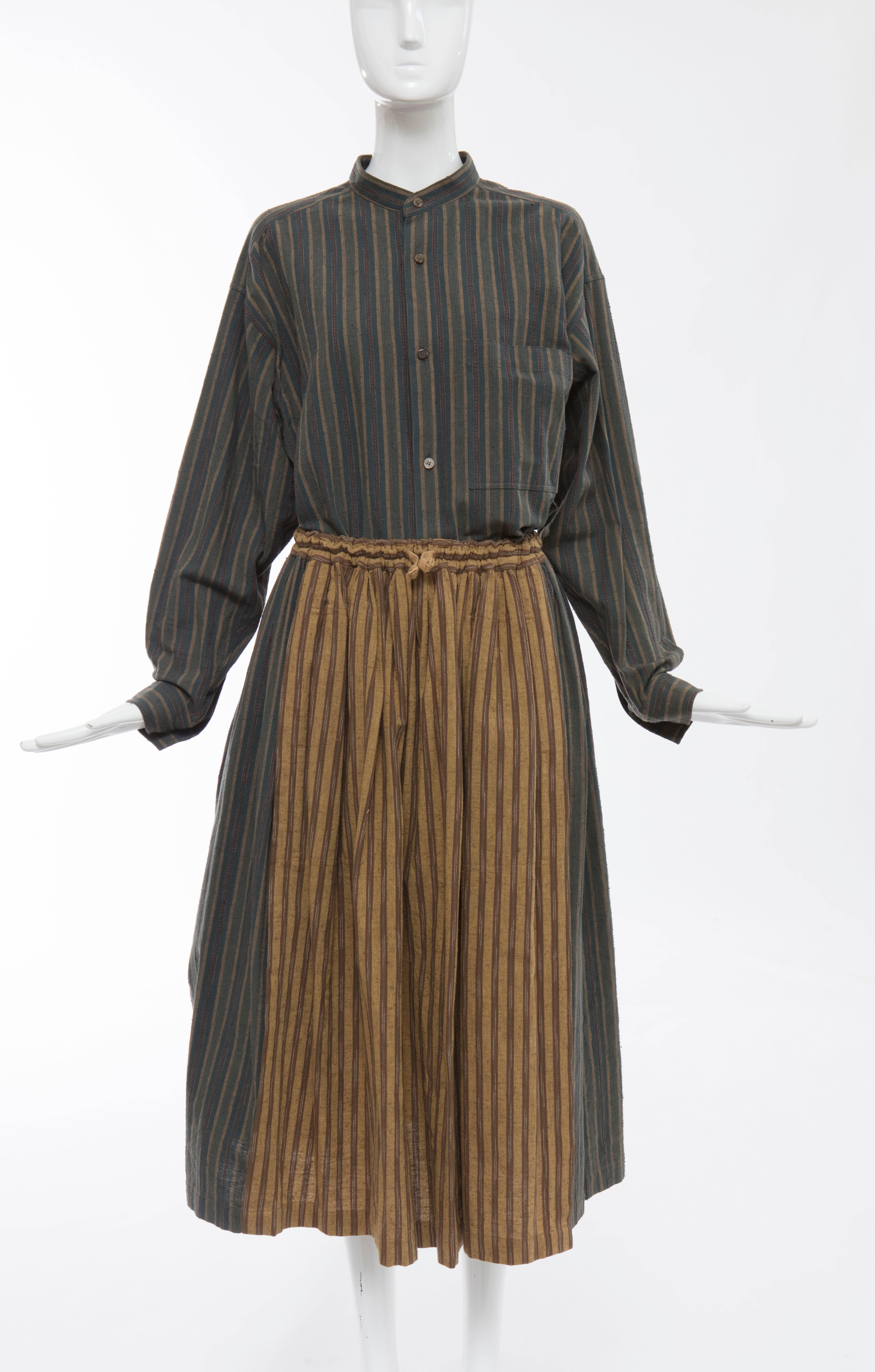Issey Miyake Plantation, circa 1980's striped woven cotton skirt suit. Button front long sleeve shirt with front pocket, elastic waist skirt with two front pockets.

Shirt Japan: Size Medium
Bust 49, Waist 48, Sleeve 21, Length 30

Skirt Japan: