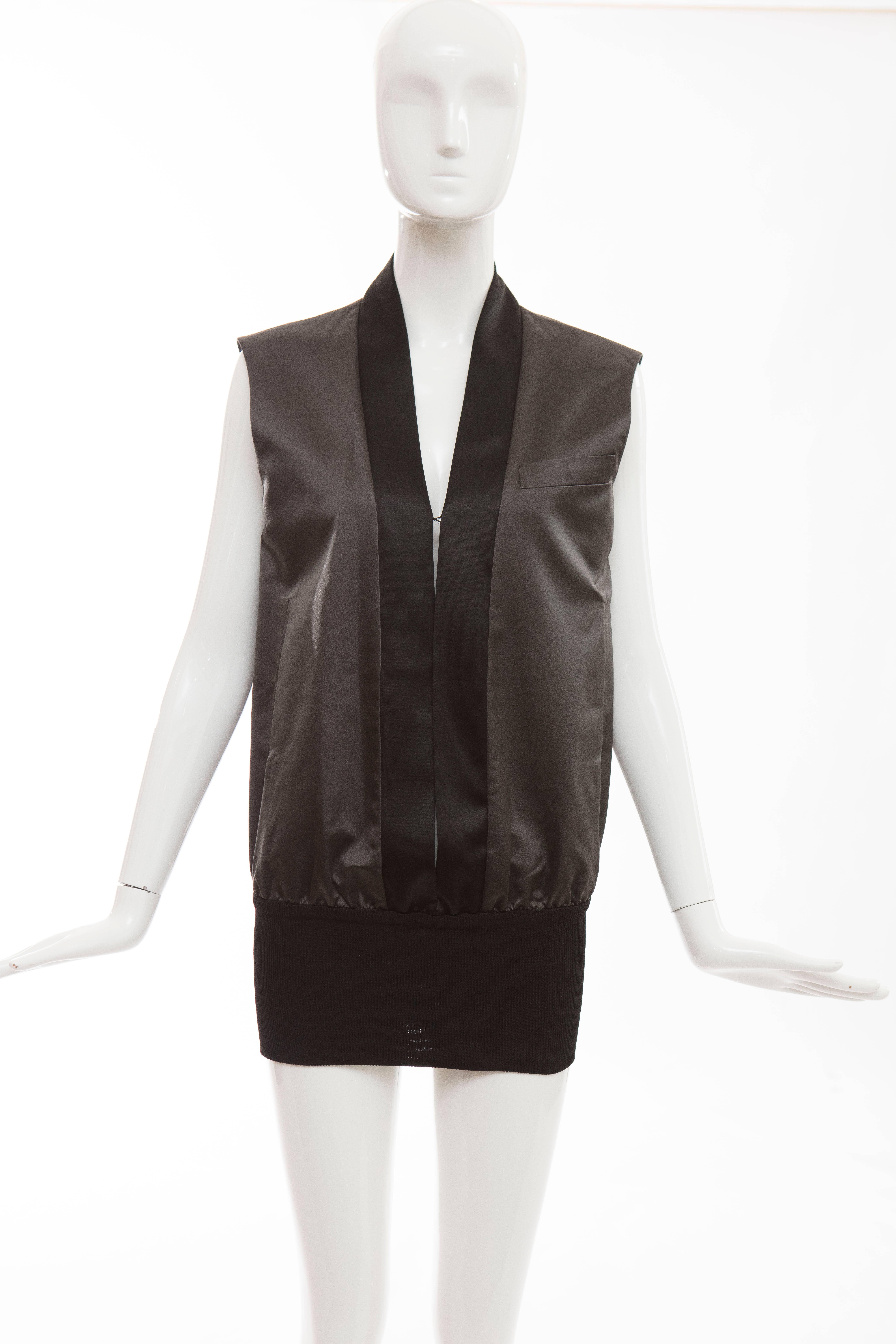 John Bartlett, Autumn - Winter 1999 (sample item) charcoal grey Duchess silk satin vest with black Duchess silk satin trim and black ribbed cotton waist, two front pockets, one faux pocket, hook-and-eye closure and fully lined.

IT. 40
US. 4

Bust