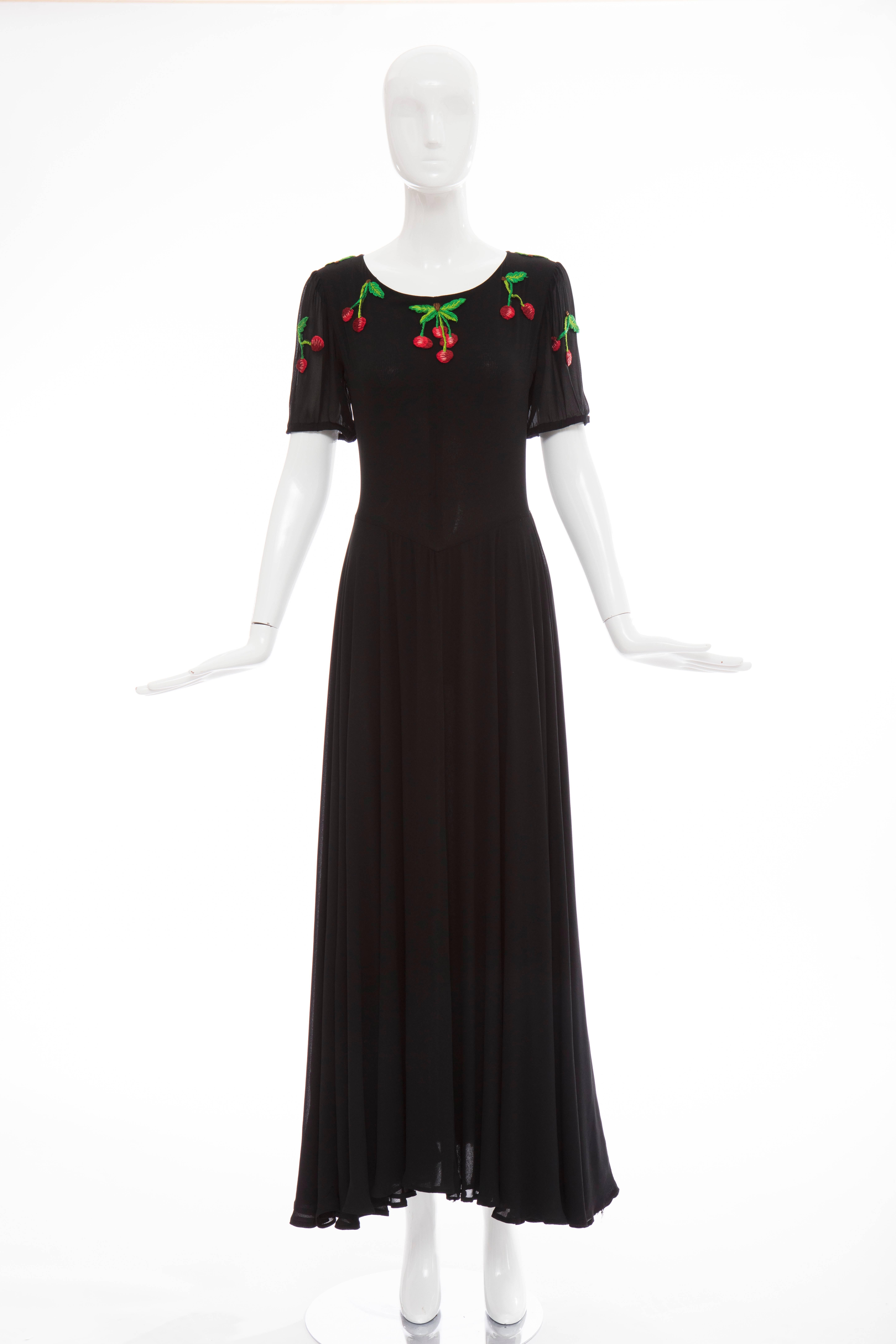 Valentino, Circa 1970's black rayon crepe hand embroidered cherries evening dress with jewel neckline, back zip and fully lined.

Label: Size 8, Modern size 

Bust 31, Waist 26, Hips 74, Length 56