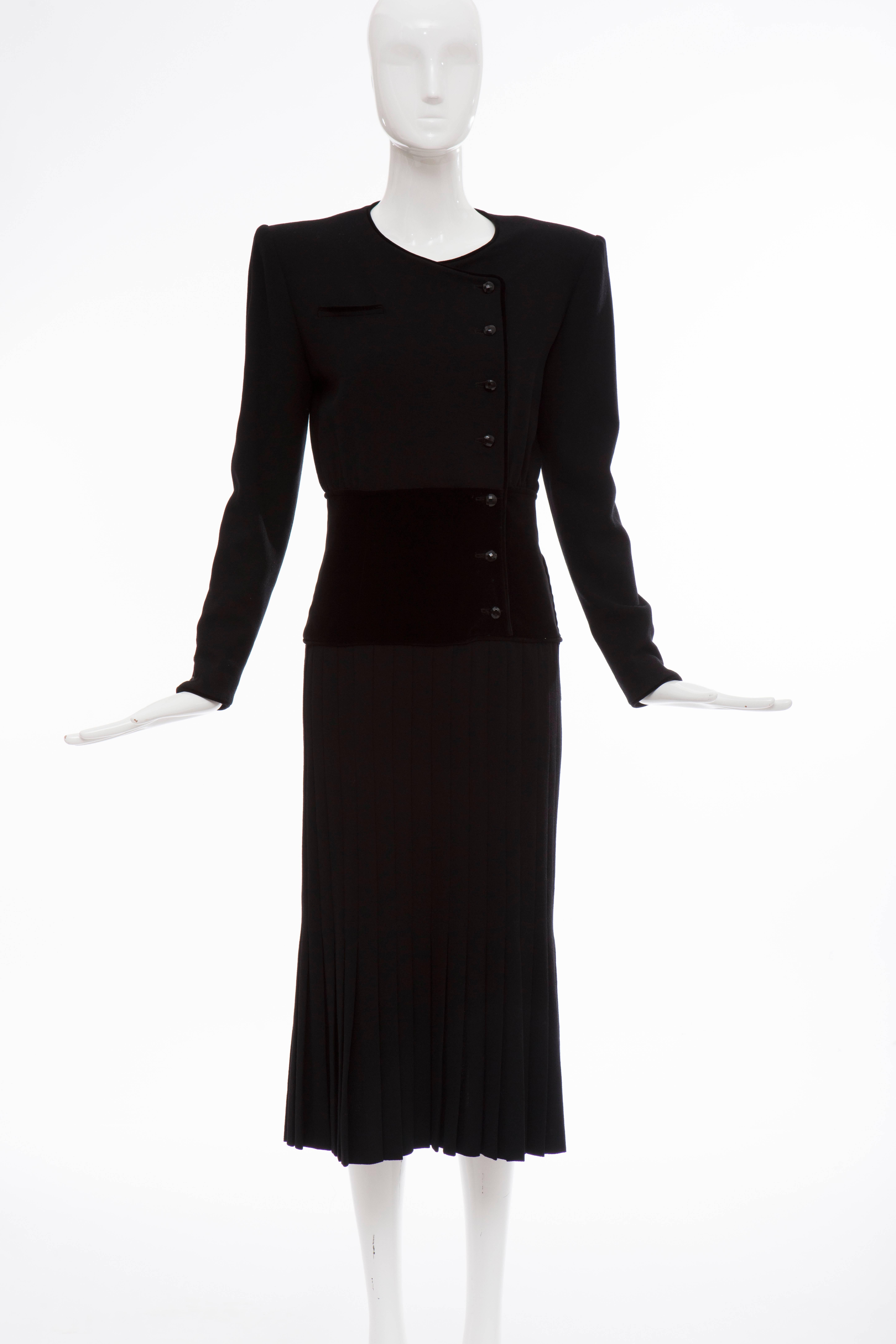 Valentino, Circa 1980's black wool crepe, button front, faux pocket and pleated skirt evening dress with black velvet waistline and lined in silk.

US. 6

Bust 37, Waist 27, Hips 34, Sleeve 23.5, Length 47.5