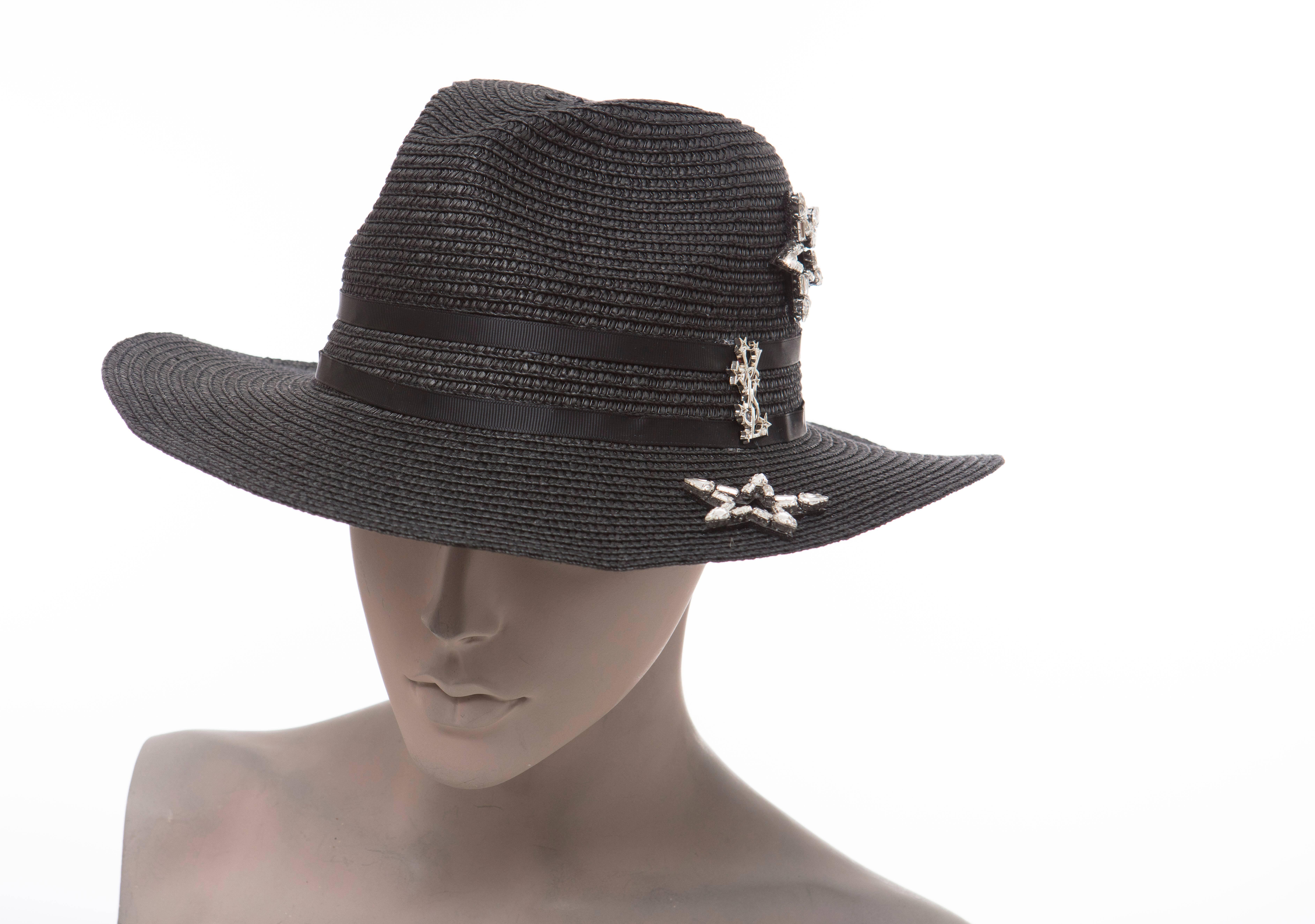 Yves Saint Laurent black straw hat with crystal embellished star featuring logo accents throughout and black grosgrain trim.

Circumference: 23.25, Brim 2.75
