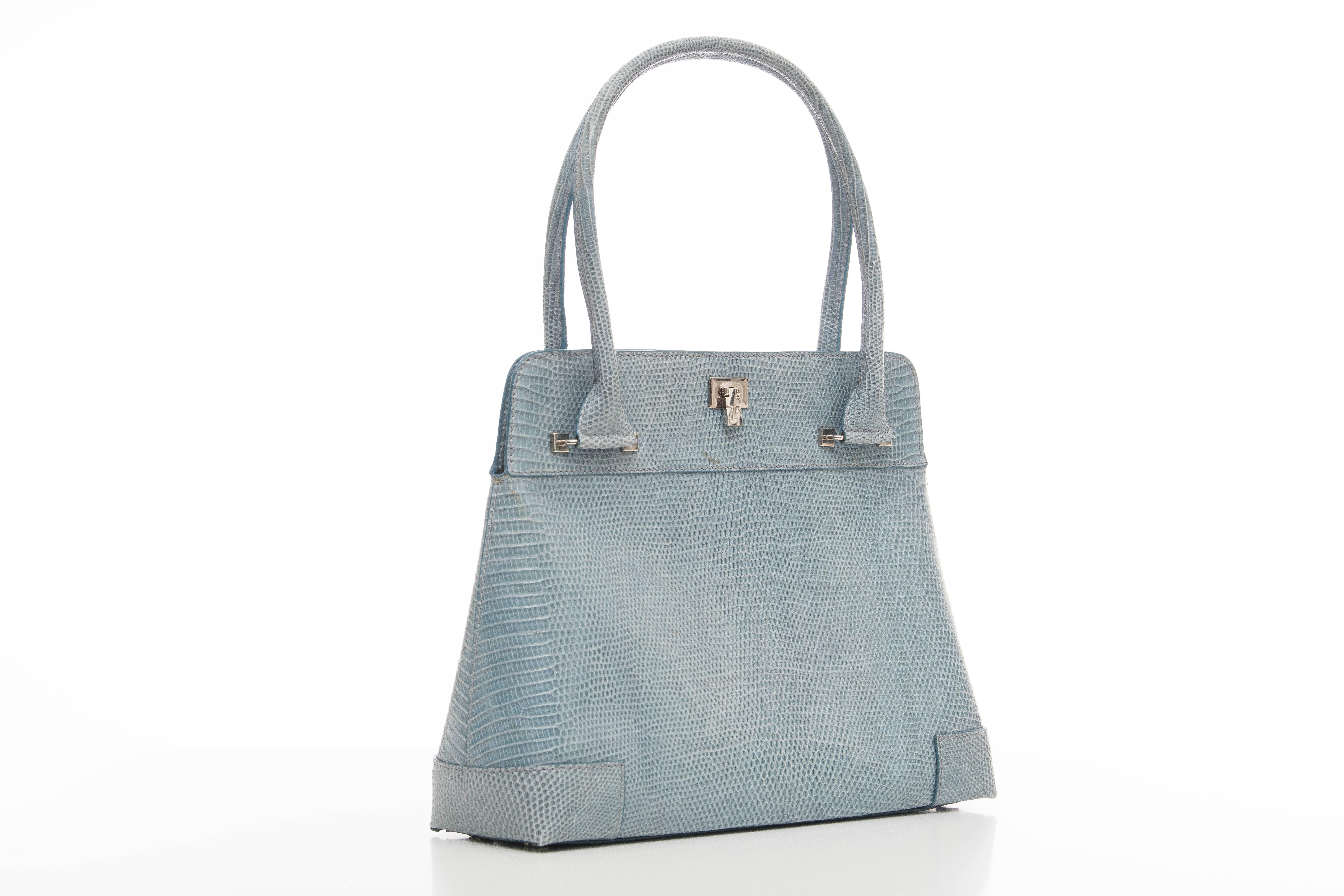 Lambertson Truex, Circa 2004 baby blue lizard handbag with silver tone flip lock closure, single zip interior pocket with three card slots and key holder and fully lined in suede.

Width 12, Height With Handle 17, Without Handle 10, Depth 4