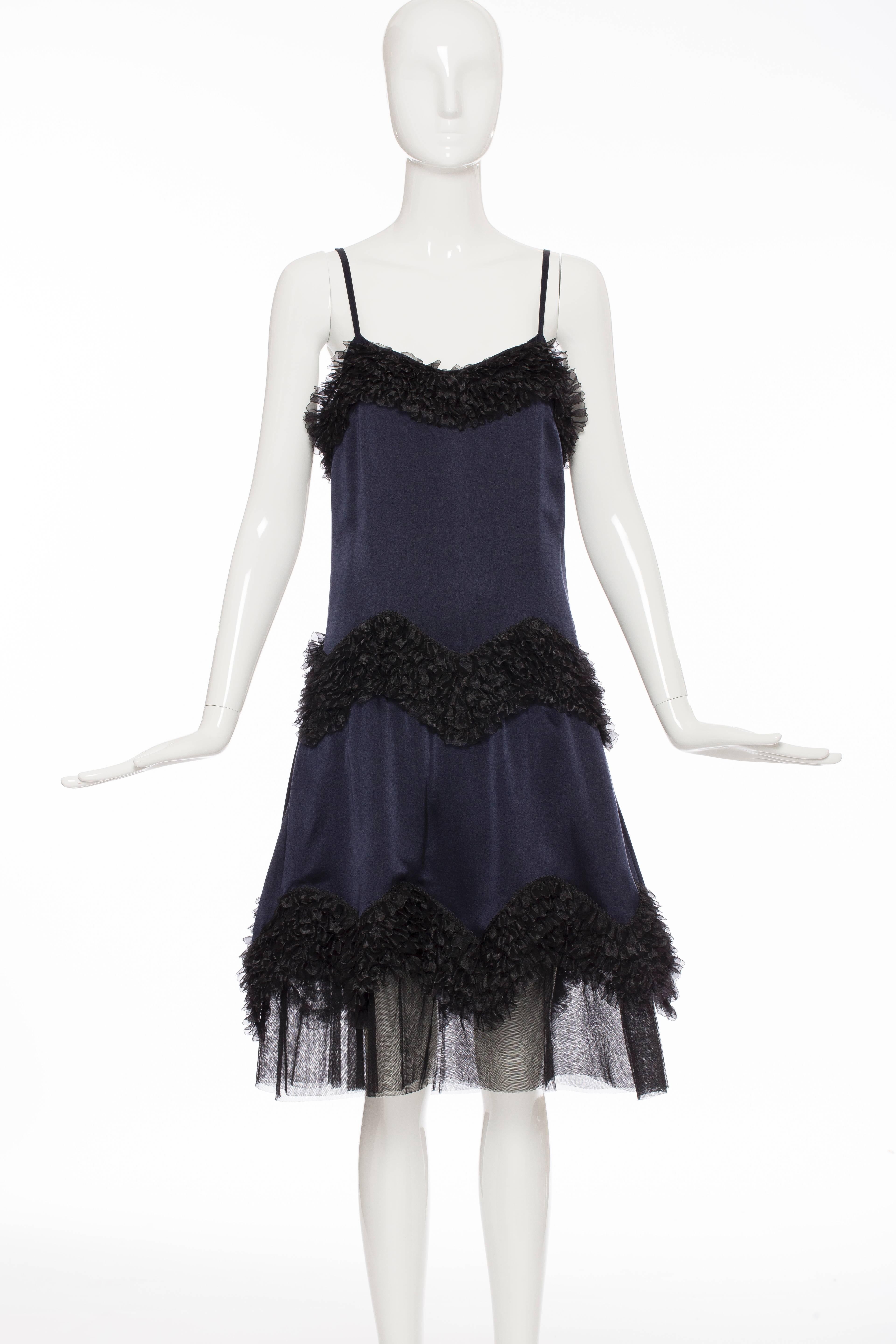 Chanel, Pre-Fall 2004, midnight blue and black silk satin  sleeveless dress with ruffled trim and back zip closure.

EU. 40
US. 8

Bust 34”, Waist 34”, Hip 50”, Length 43”