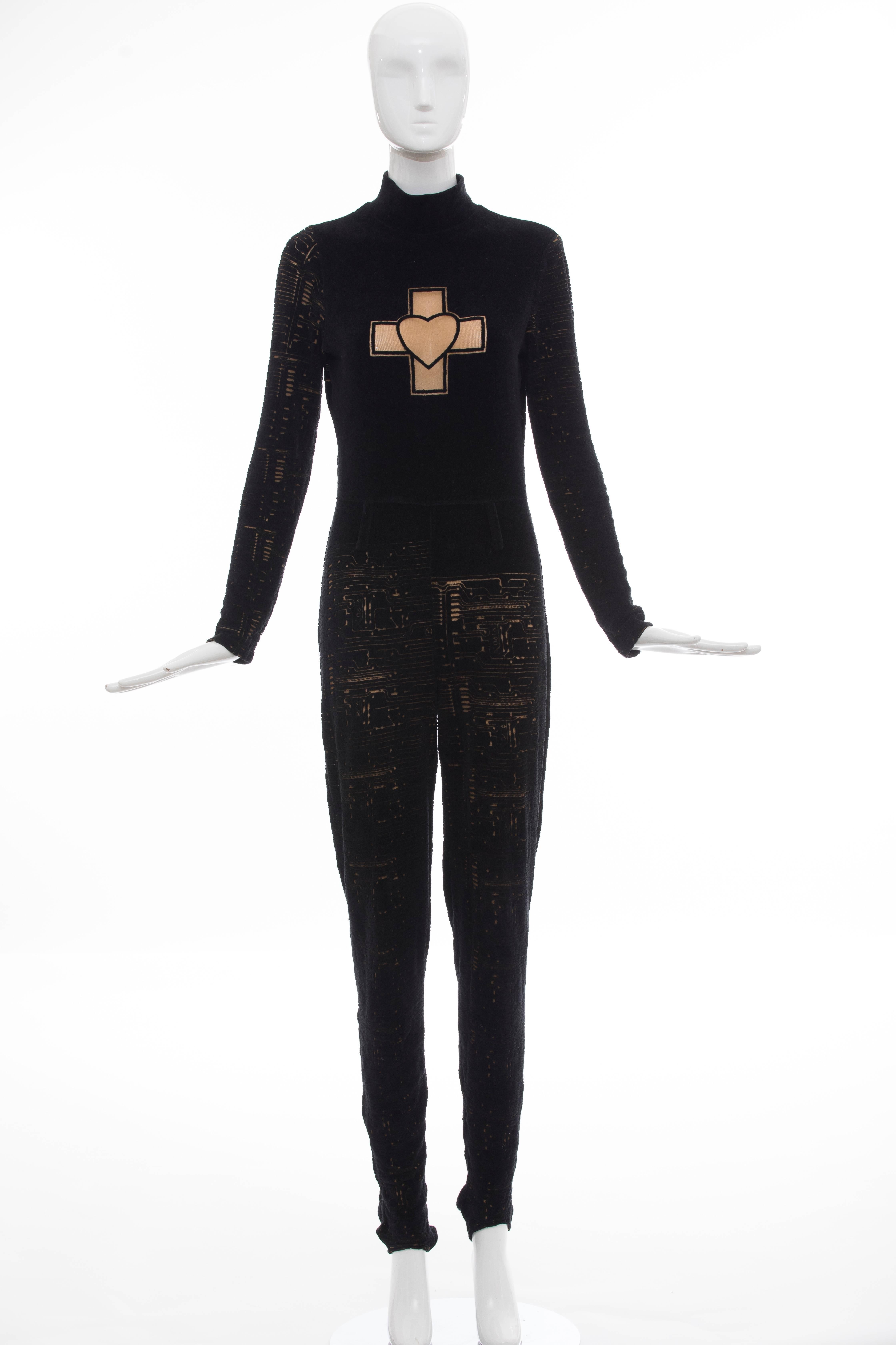 Jean Paul Gaultier, Circa 1990's black velour long sleeve jumpsuit with mock neck, devoré circuit board pattern throughout and exposed silver-tone zip closure at back. 

No Size Label

Bust: 34, Waist 27, Hip 34, Rise 12, Inseam 34.5, Leg Opening 9
