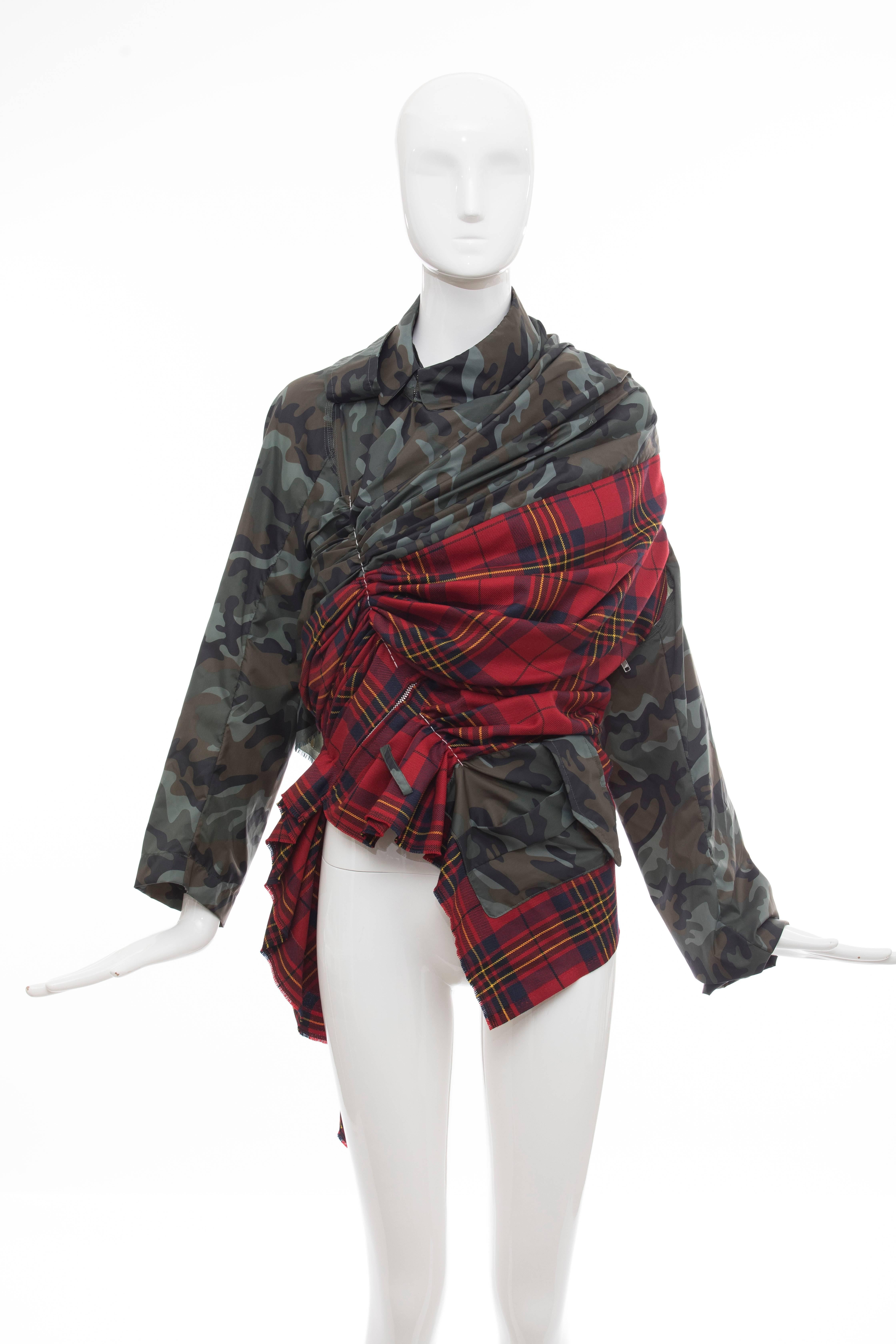 Comme des Garçons, Spring-Summer 2006 asymmetrical jacket with nylon camouflage and wool tartan plaid pattern throughout and gathered at front featuring concealed zip closure.

Japan: Small

Bust: 36, Waist 32, Shoulder 13, Length 28, Sleeve 32
