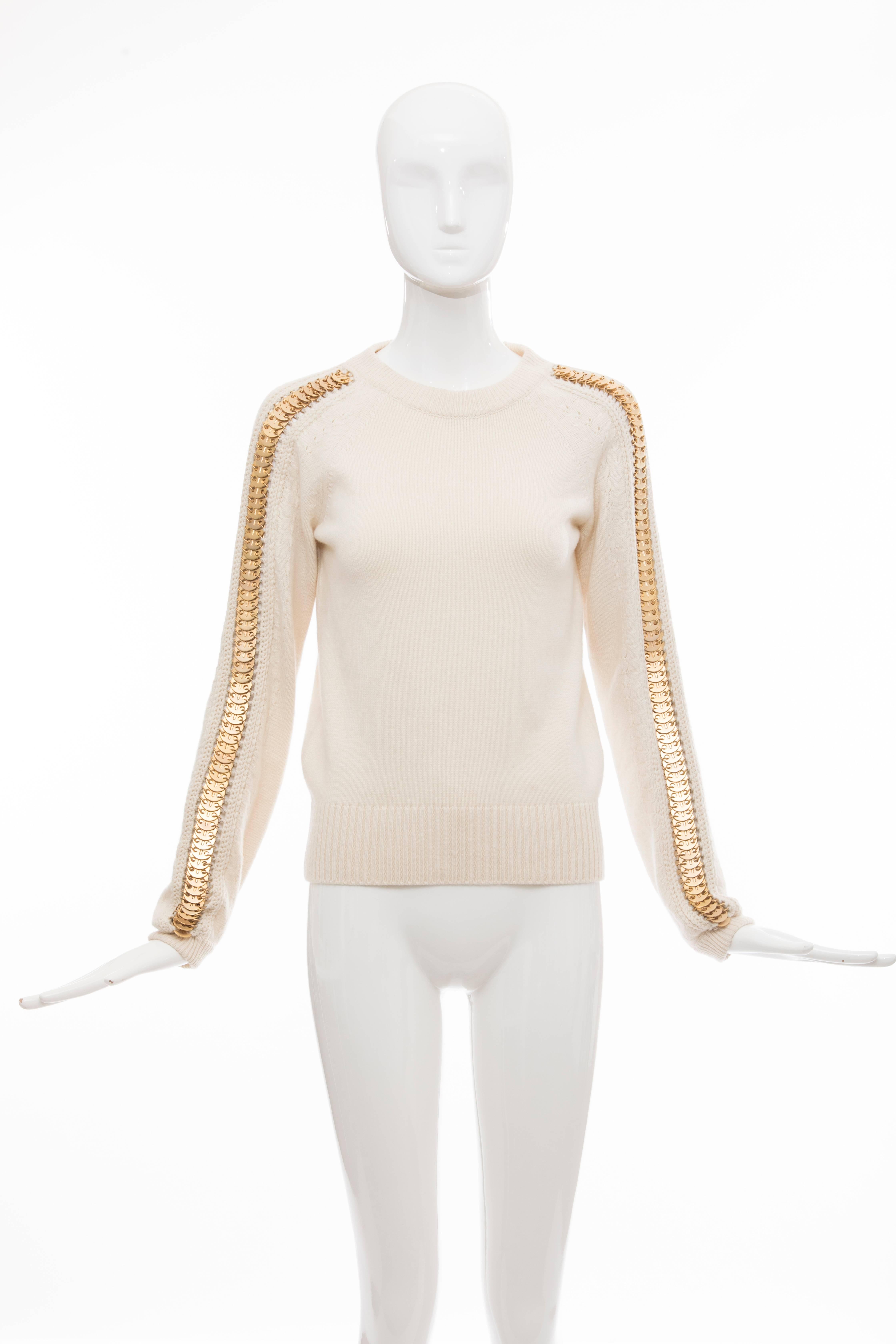 Paco Rabanne knit top with crew neck, matte golg hardware embellishments at long sleeves and rib knit trim throughout.

FR. 36
US. 4

Bust: 38, Waist 38, Length 23
