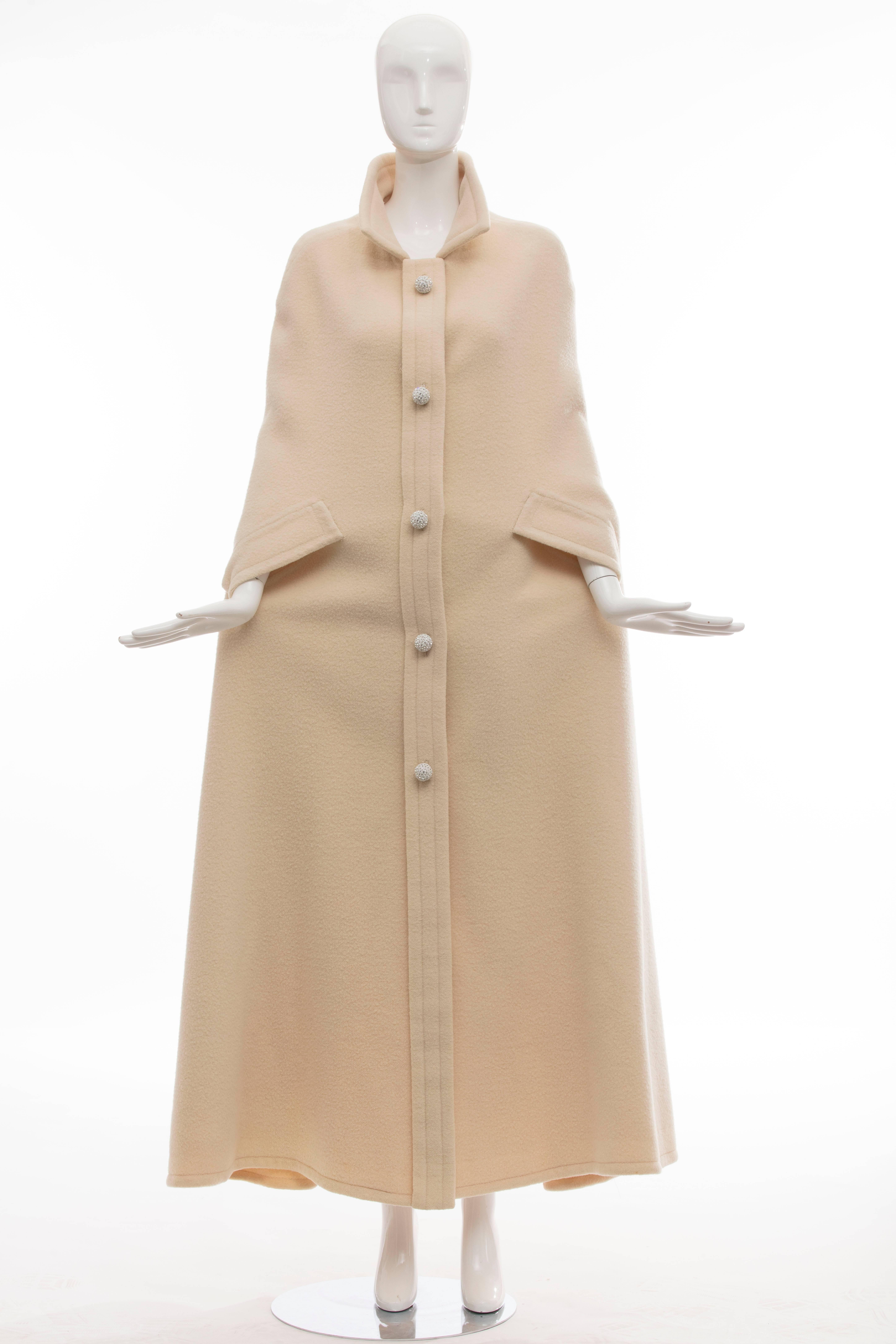 Christian Dior Haute Couture by Marc Bohan Autumn-Winter 1966 cream wool cape with pointed collar, dual slits at sides and diamante embellished contrast snap closure at center front.

No Size Label

Length 57