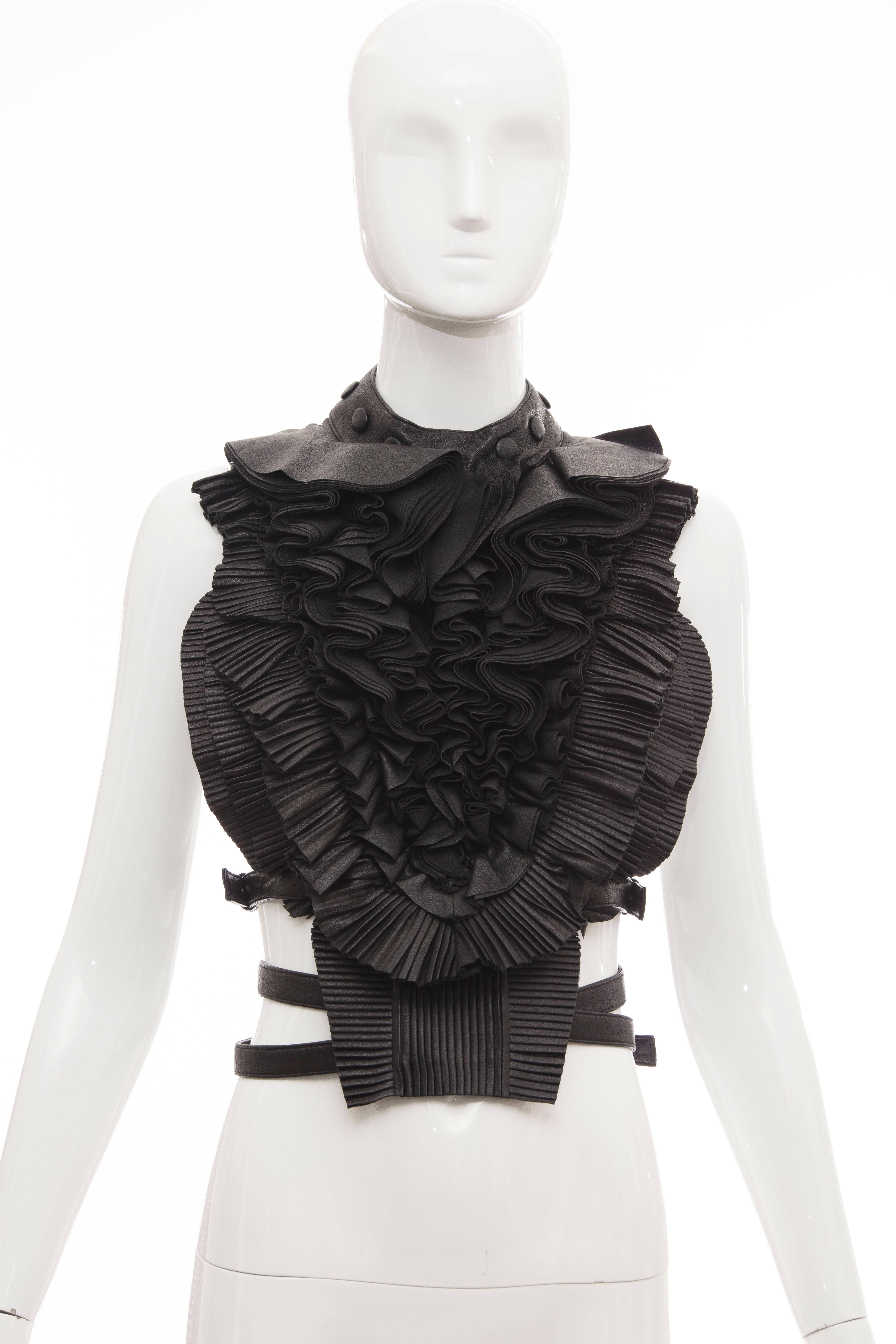 Riccardo Tisci for Givenchy runway (Look 16) black leather pleated ruffle harness top with scoop neck, open back and adjustable metal buckle closures throughout and fully lined.

The harness top is part of the FIT Museum's collection.

One