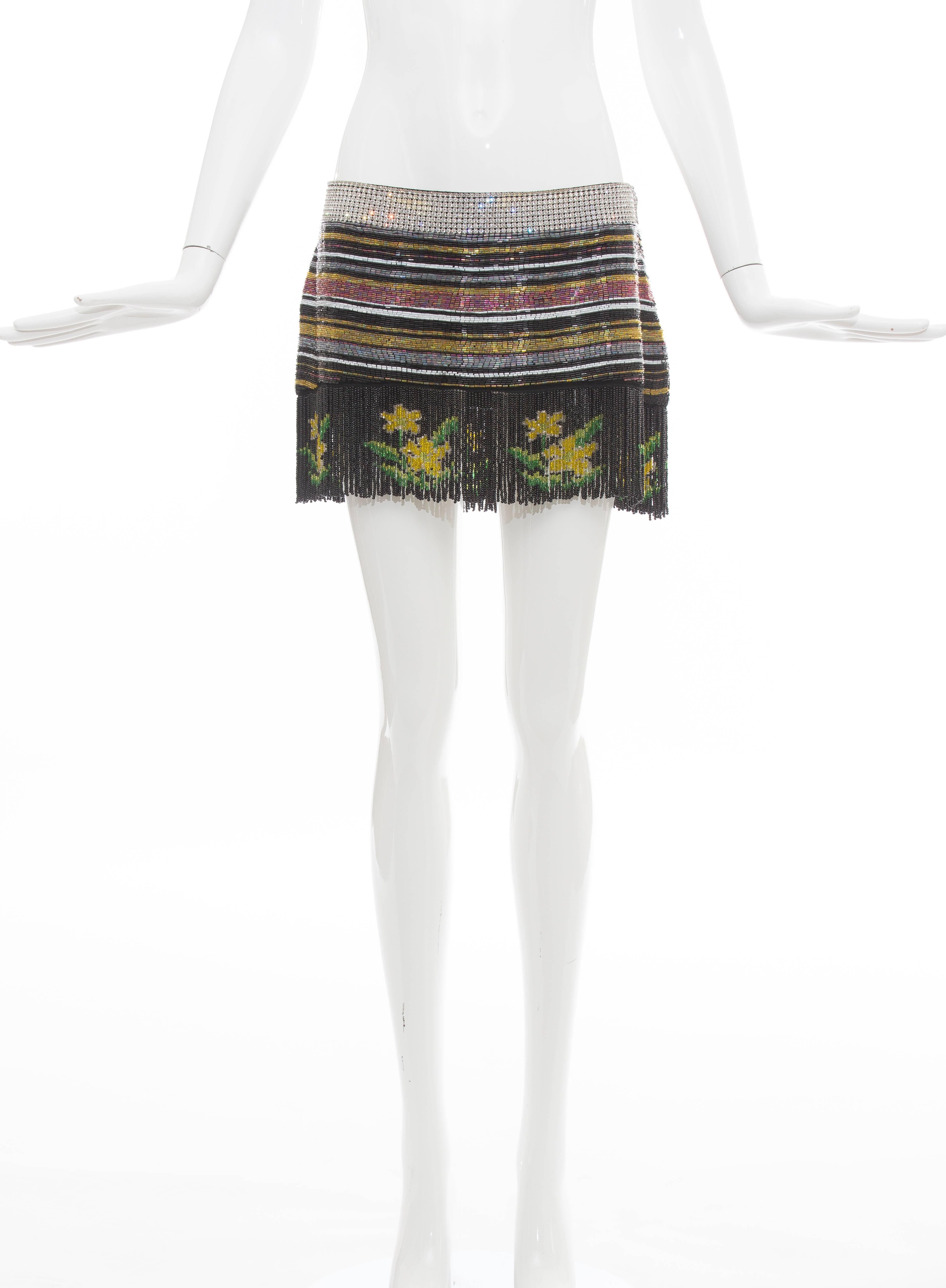 Dolce Gabbana, Spring-Summer 2000 silk mini skirt with beaded embellishments throughout, crystal waistband, fringe trim at hem and zip closure at side.

IT. 42
US. 6
Waist: 32, Hip 37, Length 12.5
