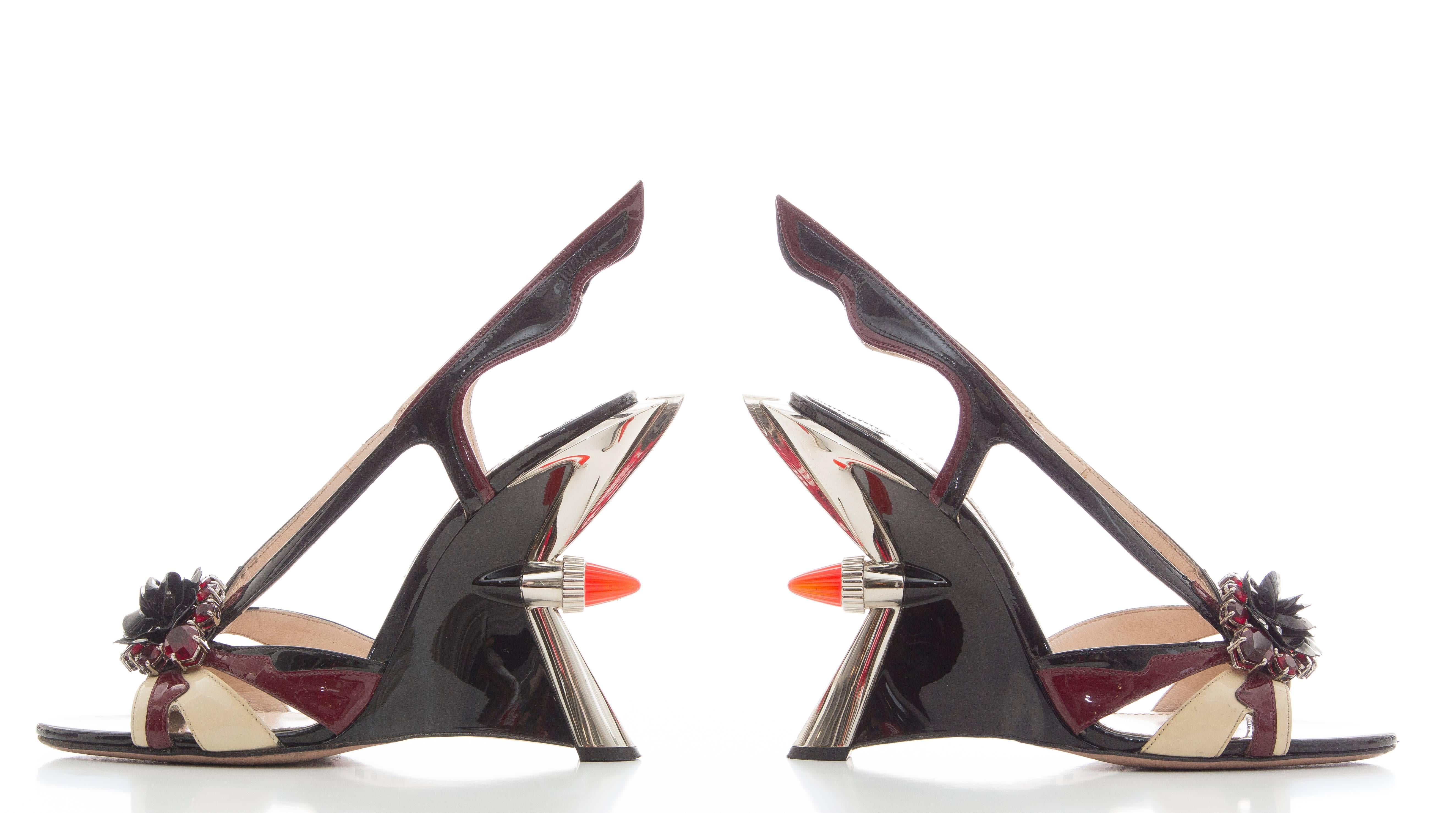 Prada, Spring-Summer 2012 jewel taillight wedge sandal with flame accents at sides, floral appliqué at tops featuring crystal embellishments and resin heels.

IT. 37.5
US. 7.5

Heels: 5
