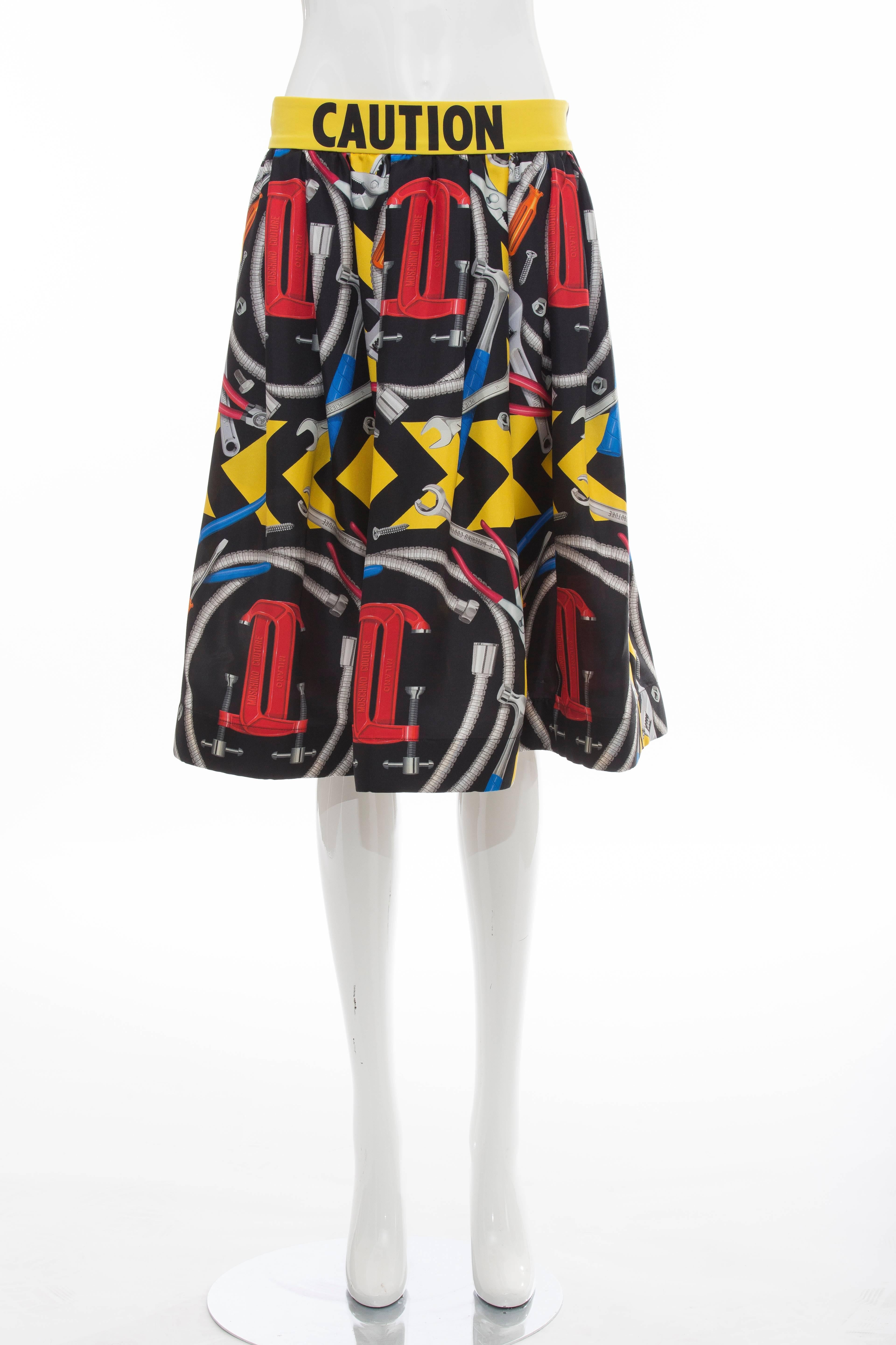 Jeremy Scott for Moschino Couture Runway (Look 32), Spring-Summer 2016 silk skirt with tool-accented print, graphic print at waistband, flounce hem and tonal stitching throughout.

IT. 48
US.12

Waist: 32, Hip 32, Length 25.5
