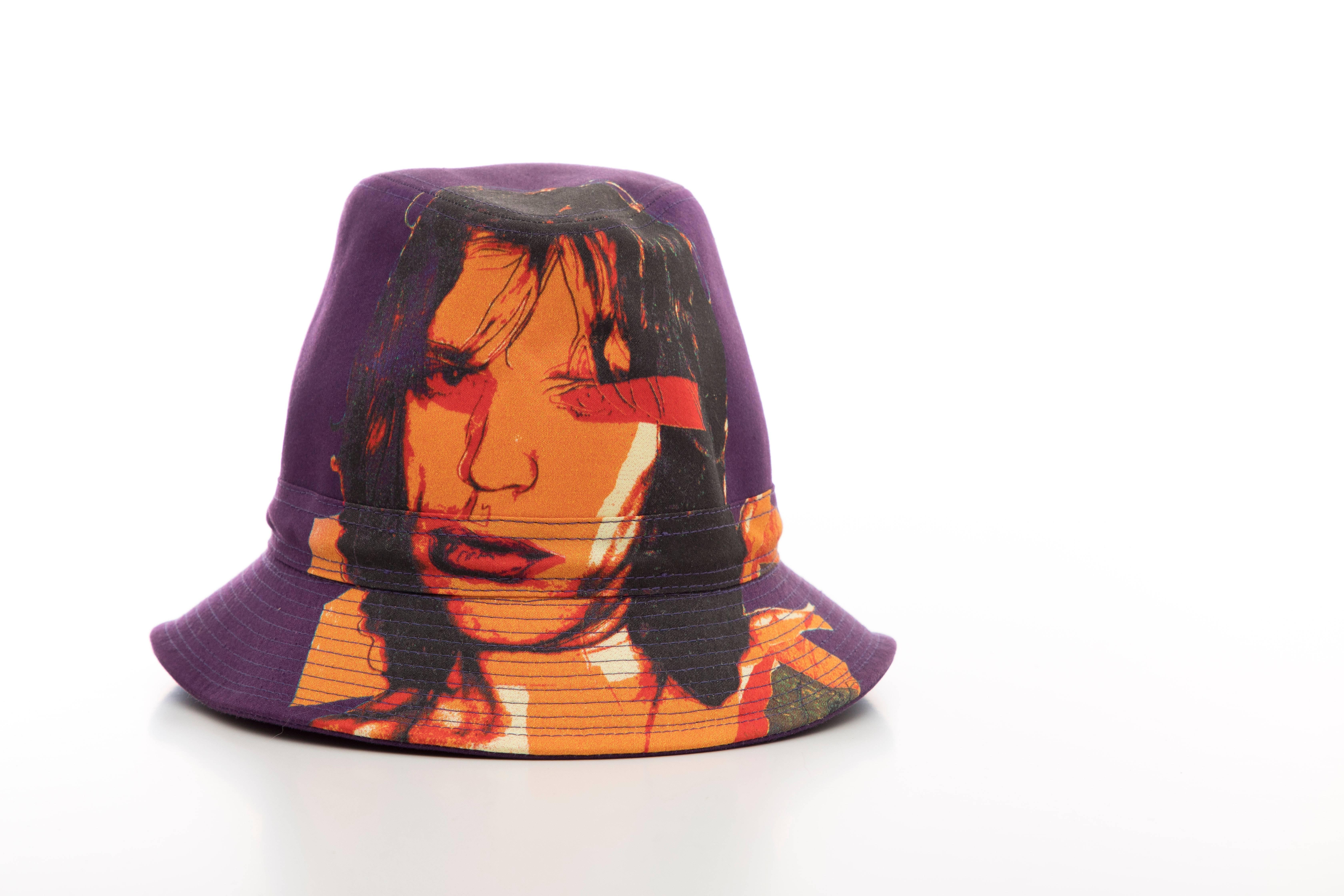 Philip Treacy, Circa 2006 purple woven printed cotton Mick Jagger Bucket hat lined with the  iconic Campbell Soup print.

Designer Size: Medium

Circumference: 23, Brim 1.75
