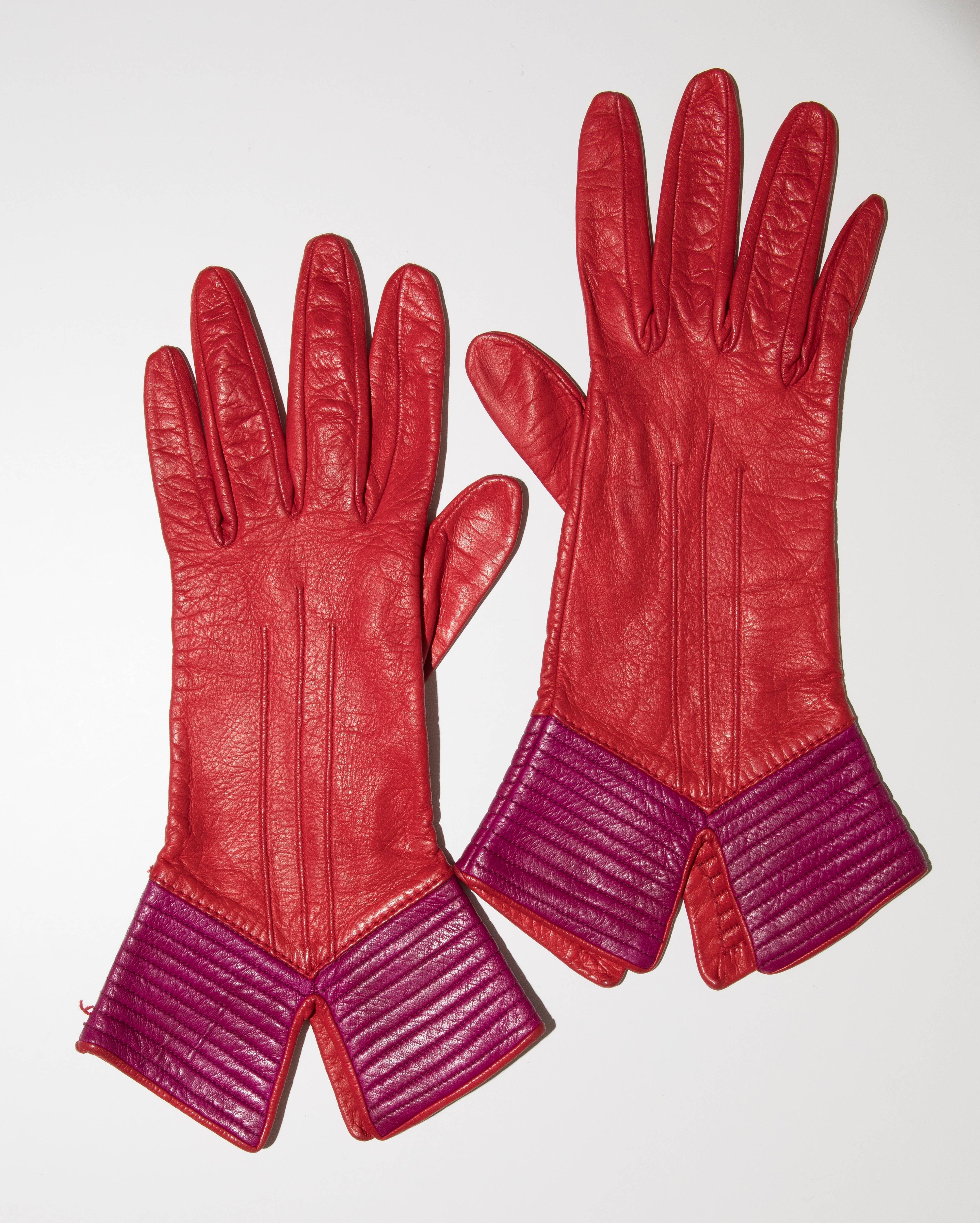 Yves Saint Laurent, circa 1970's red and purple color-block leather gloves featuring tonal stitching and lined in silk.

Size: Large

Length: 12