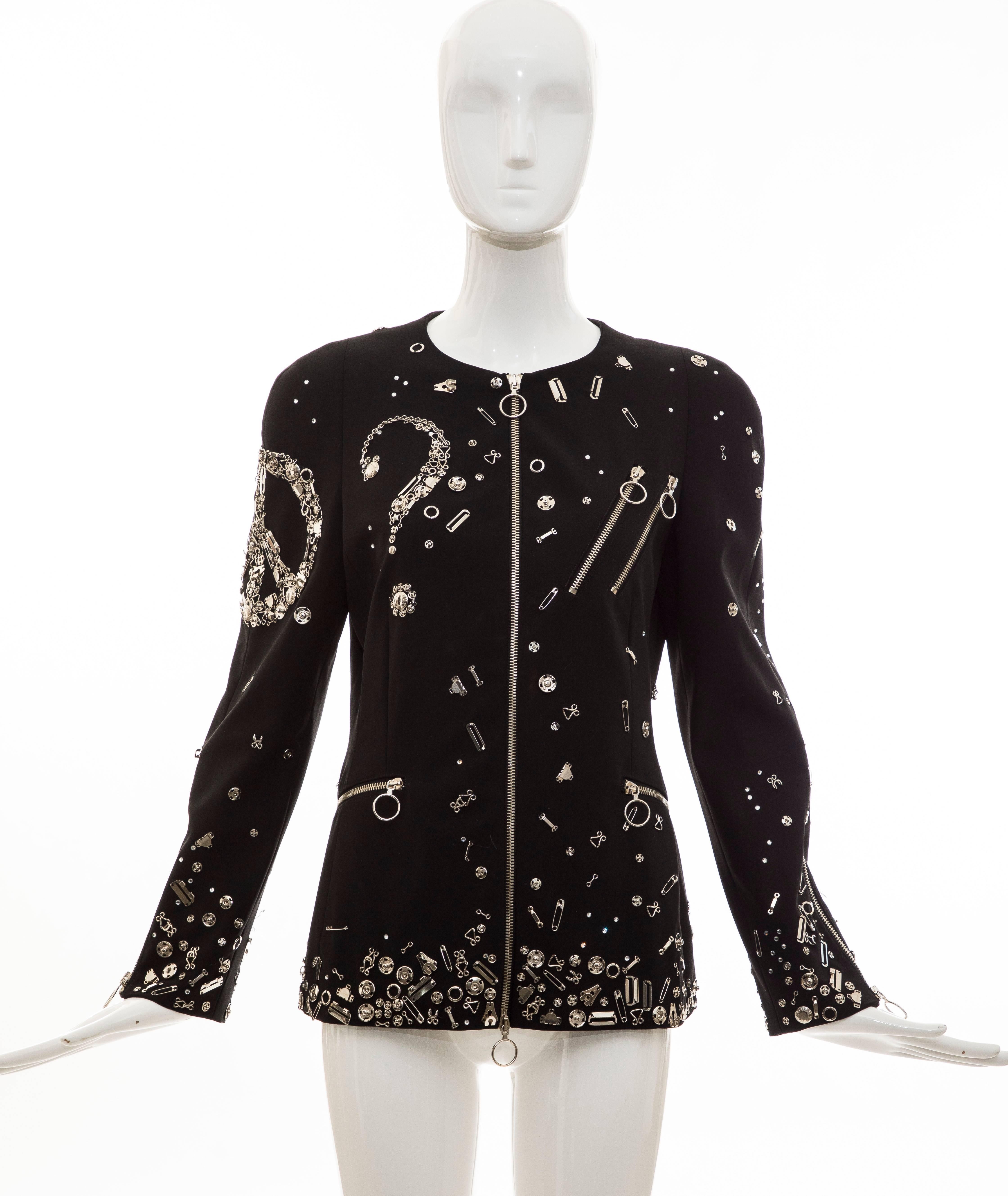 Black Moschino Couture, Fall 2009 black  jacket featuring safety pin accents throughout, heart shape embellishment at back, zip accent at back hem, structured shoulders, four zip pockets and exposed zip closure at center front. 

IT: 44, US: