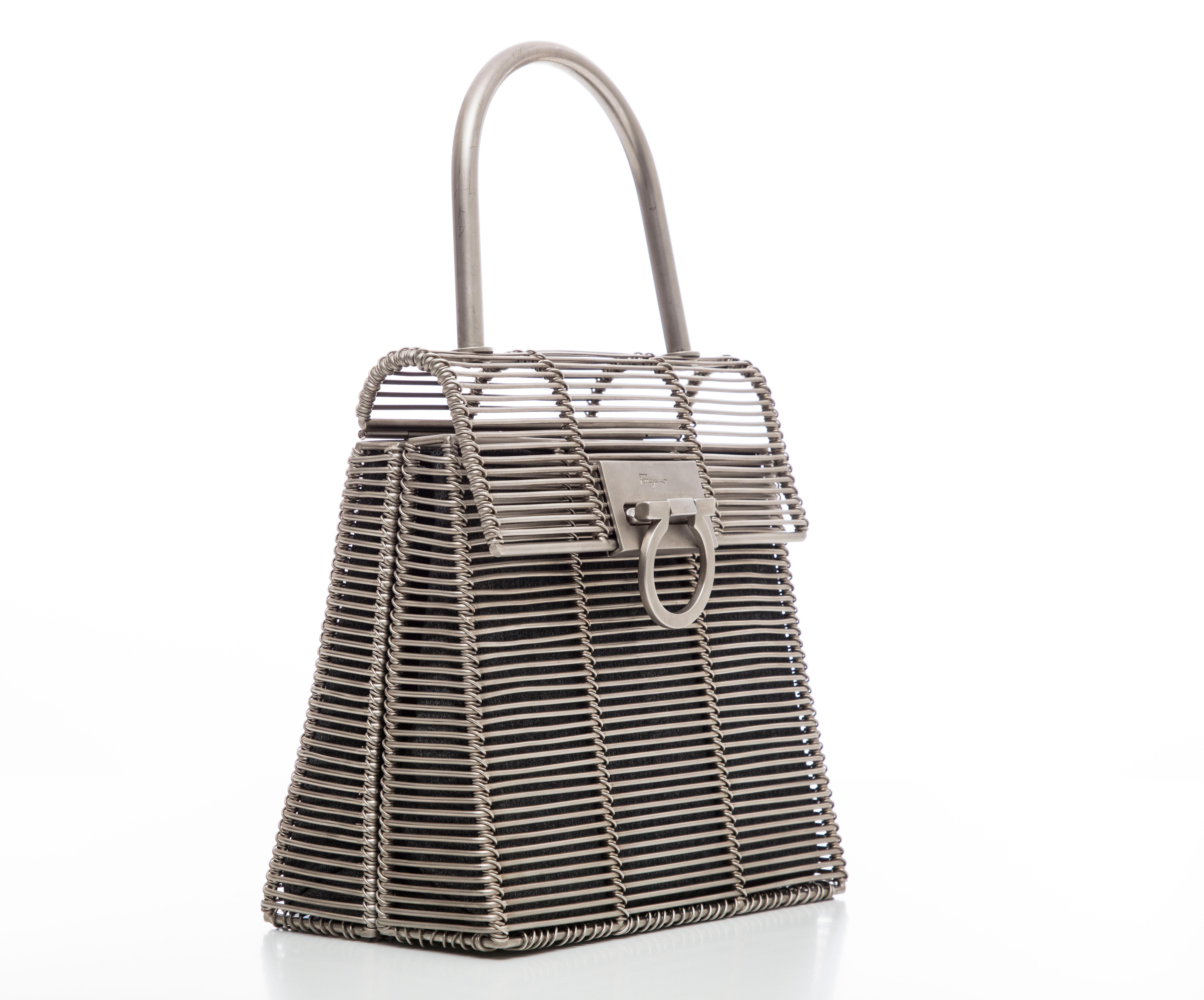  Salvatore Ferragamo, Circa: 1999 classic metal bag with Gancino magnetic fastening, tonal hardware, single rolled top handle, black woven lining with single pocket at interior wall.

Published Skira: Salvatore Ferragamo 