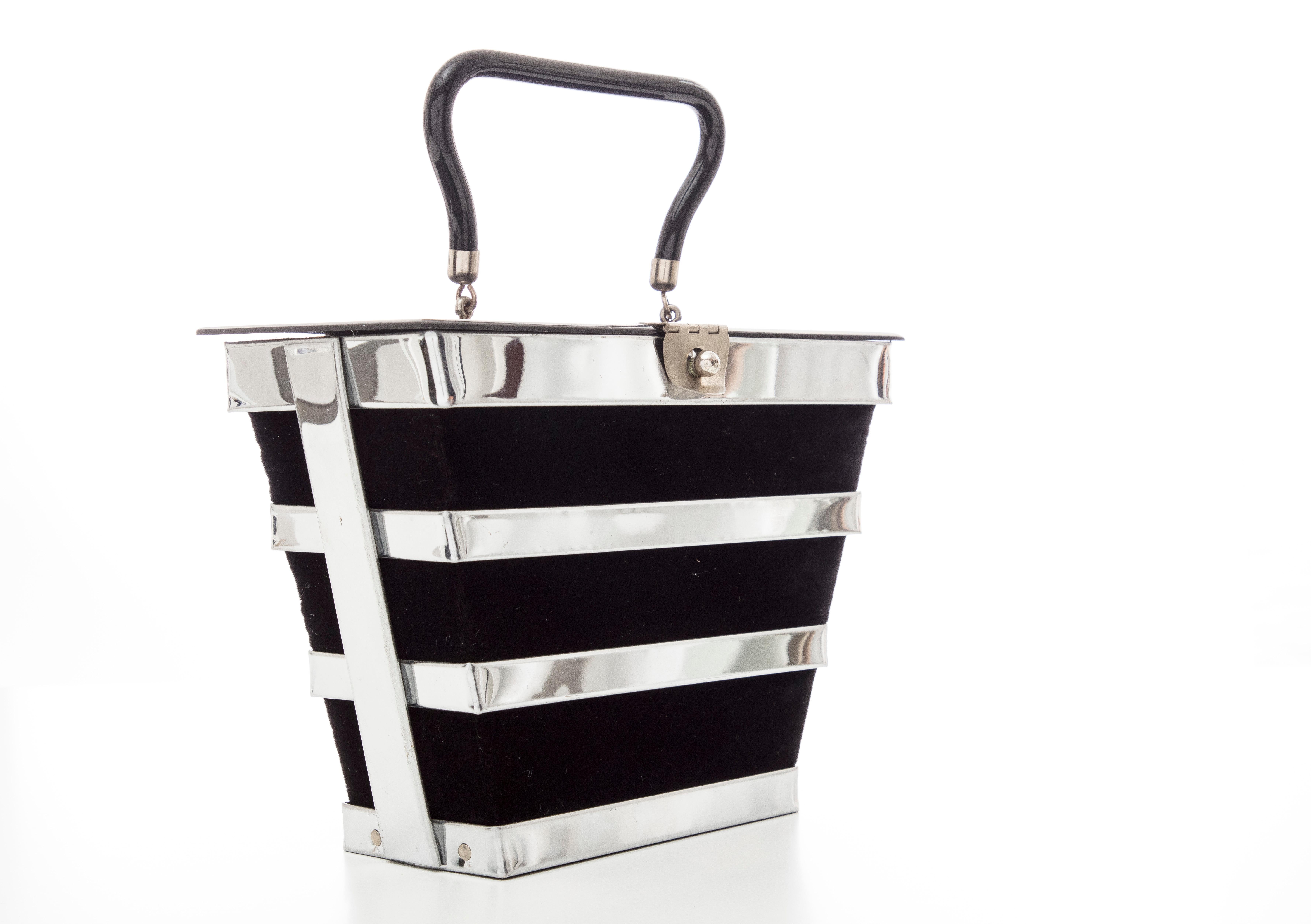Dorset Rex, Circa: 1950's chrome caged top handle bag with black velvet exterior, lucite top and handle, lined in satin with one interior pocket.

Width: 9, Height: 7, Depth: 4.5