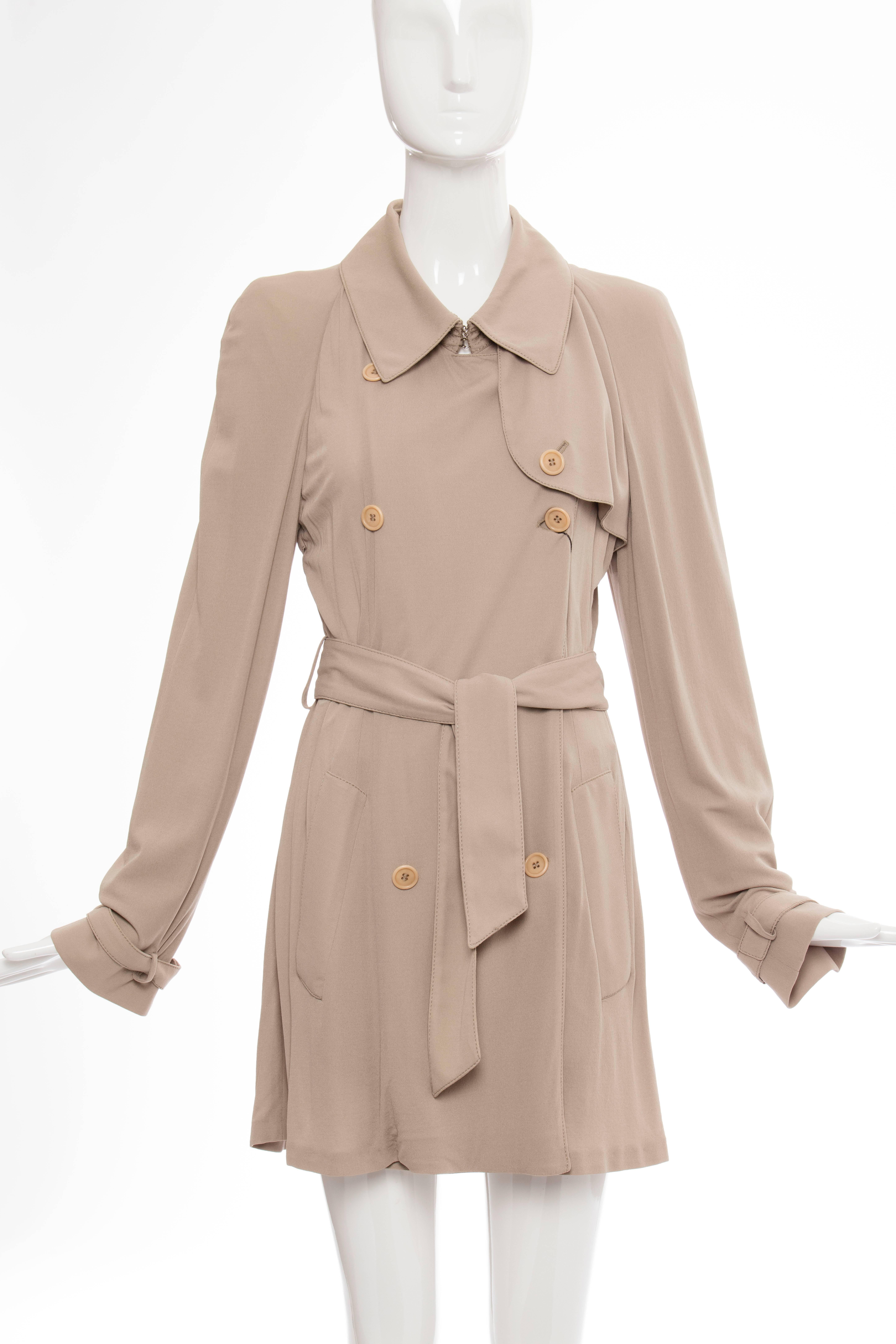 Double-breasted short light weight jacket with belted sleeves and two pockets.