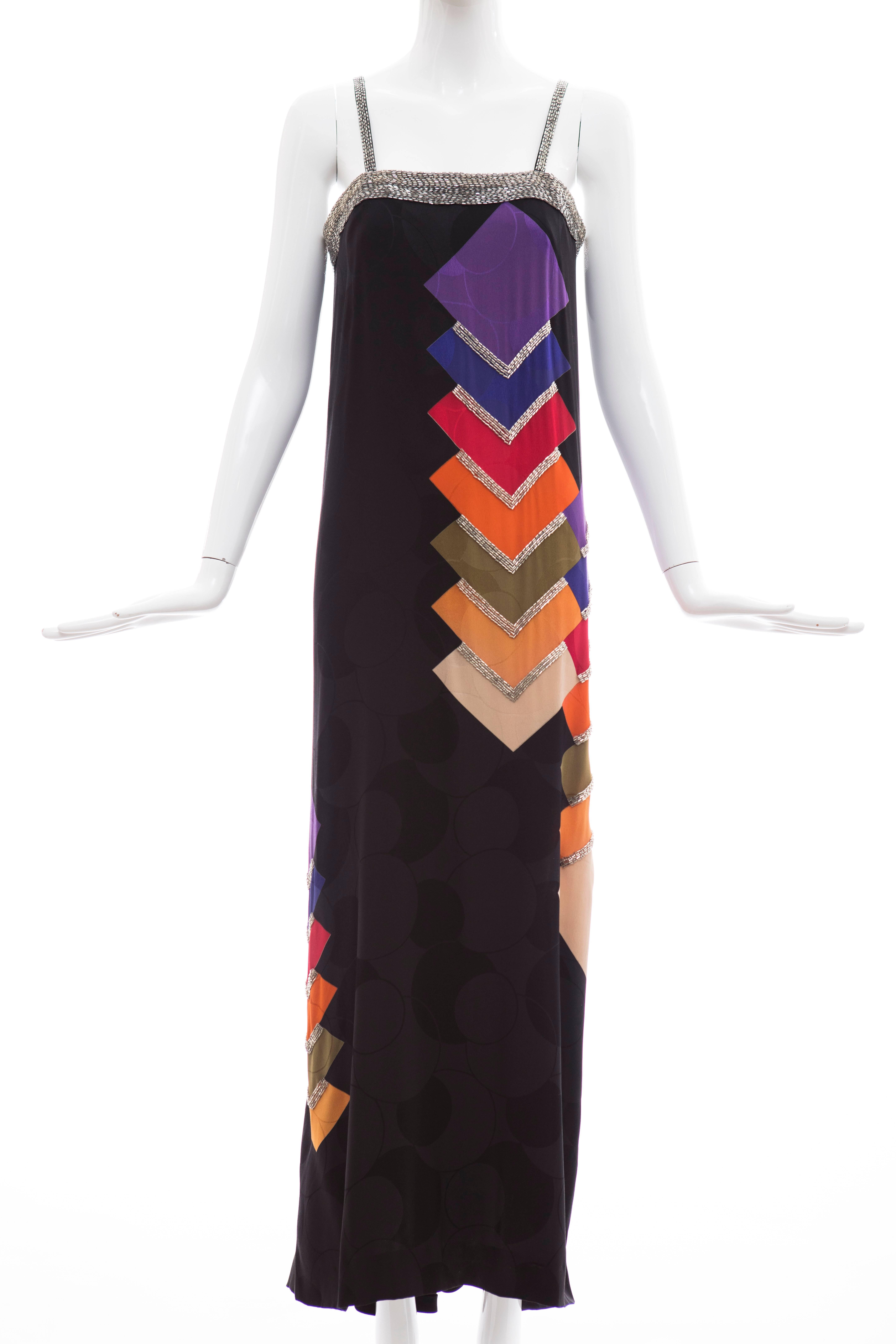 Bob Mackie, circa 1990's black silk dress with multicolored screen-print, the fabric has a circular pattern to background and has inset boning in bodice,silver beaded straps and back zipper.

US. 10 fits 8

Bust 34,  Waist 36, Hips 39, Length 57
