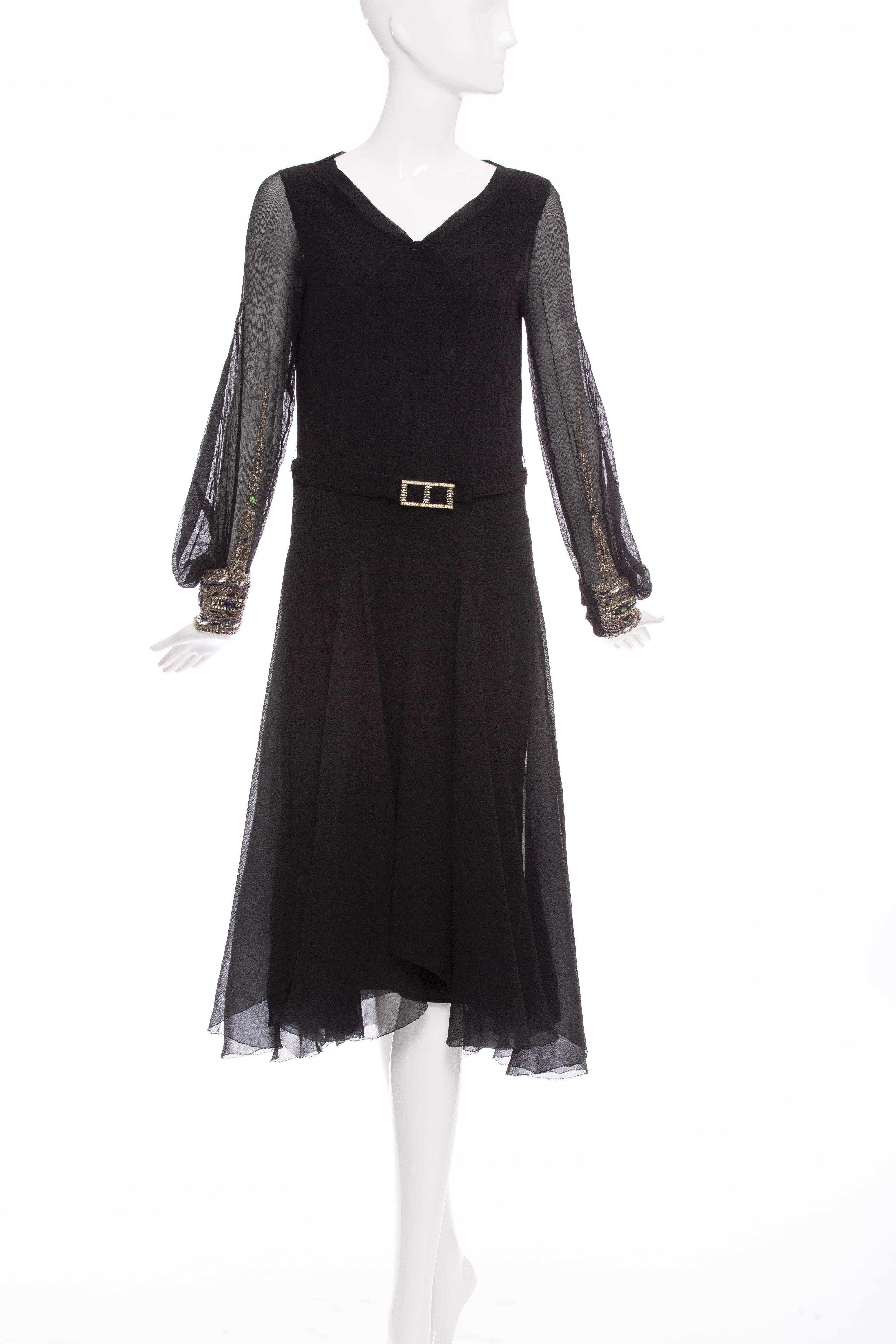 Circa 1930's, silk chiffon dress, V front, bishop sleeve with glass bead work, attached belt with embellished buckle and multi-layered chiffon skirt with godet detail.