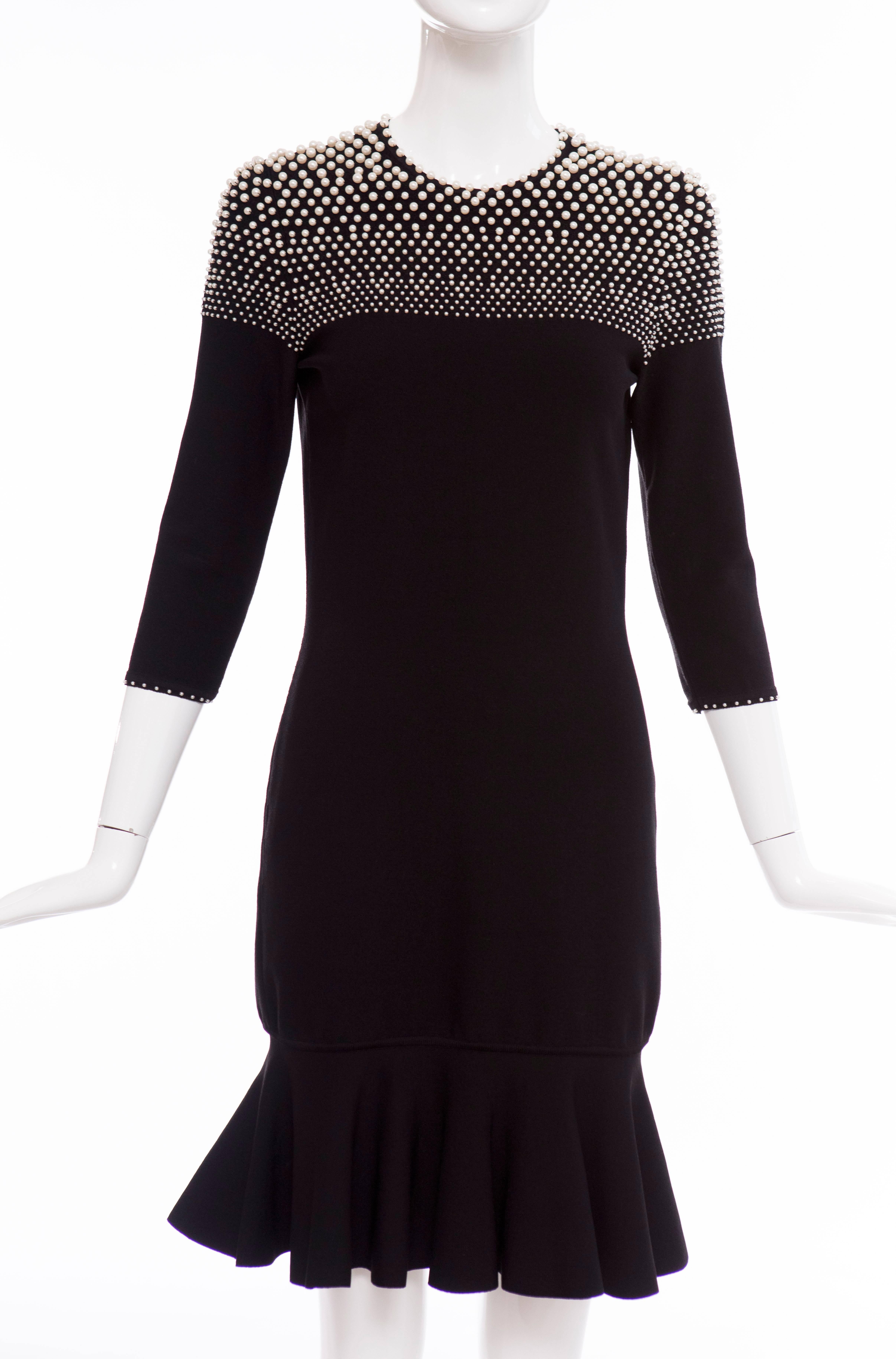 Alexander McQueen Autumn-Winter 2013, black long sleeve knit dress with round neckline, faux pearl embellishments at top throughout, embellished trim at sleeve opening, flared hem and keyhole at center back featuring button closure at nape.

Bust