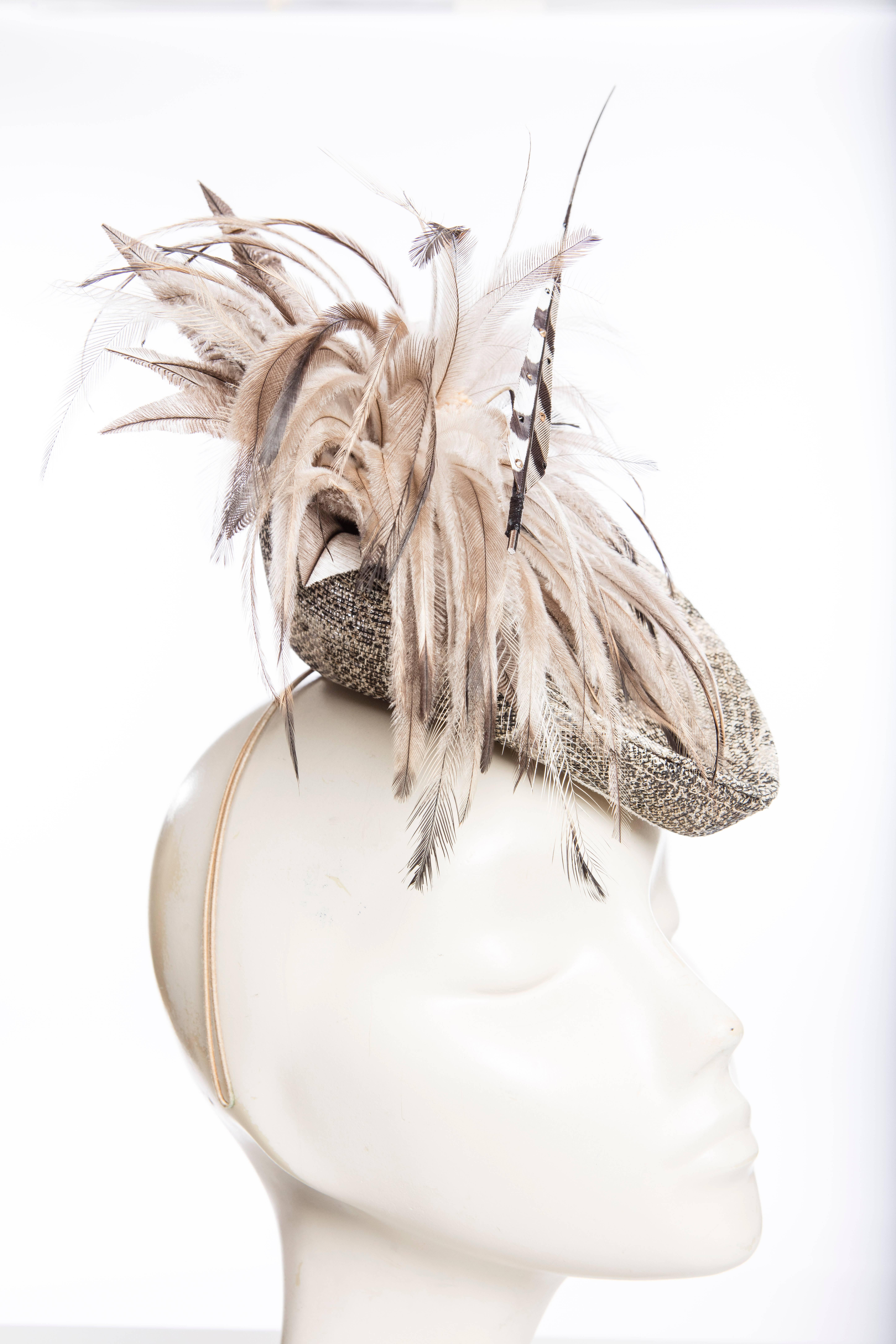 Philip Treacy Fascinator with feather appliqué at side and headband featuring concealed hair comb. Includes box.

Circumference 13.5”