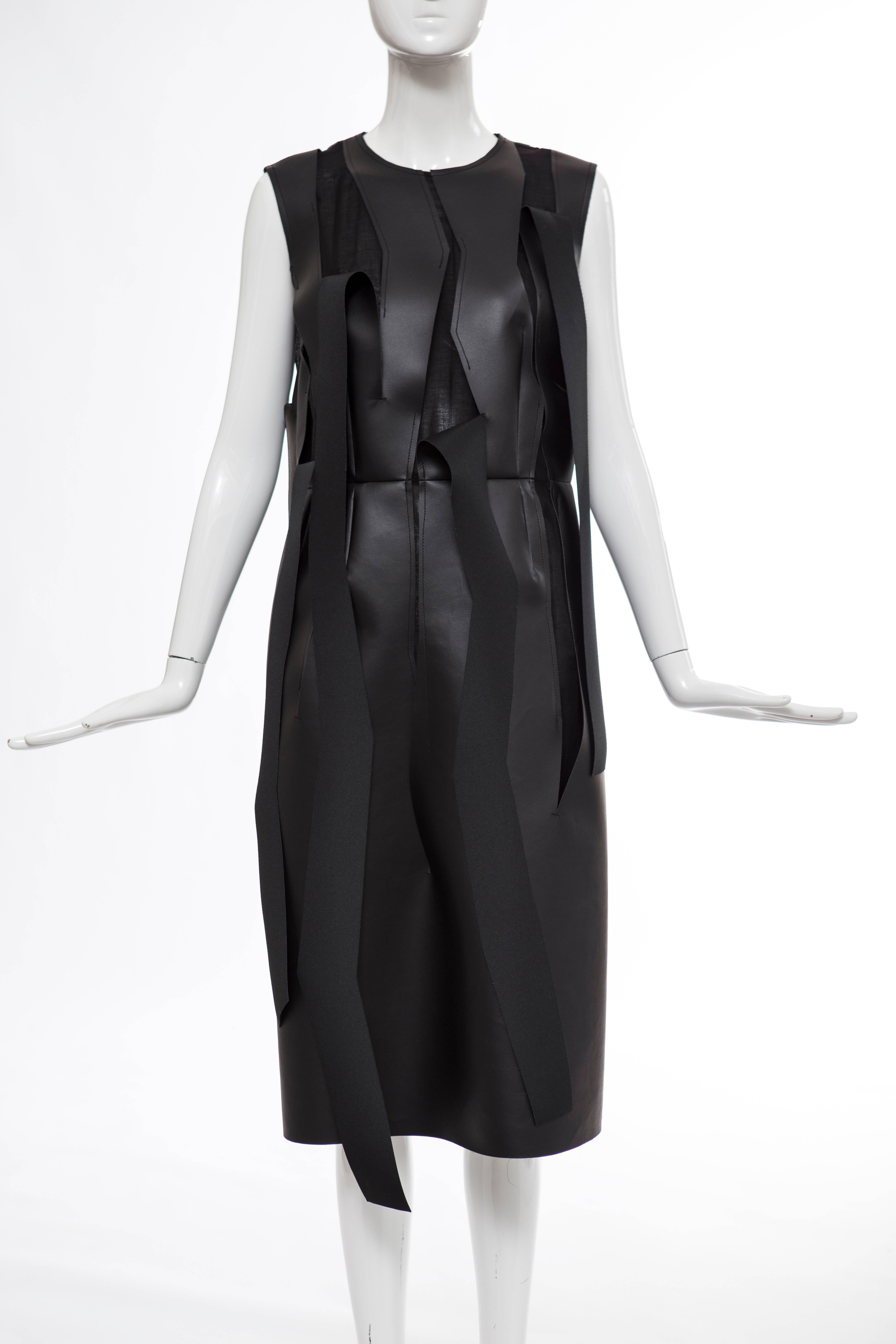  Comme des Garçons, circa 2014, faux leather sleeveless, sheath dress with cutout strips throughout, round neckline, back zip closure and fully lined.

Japan: Medium

Bust 37”, Waist 33”, Hip 40”, Length 45”

Fabric Content: 100% Synthetic Leather;