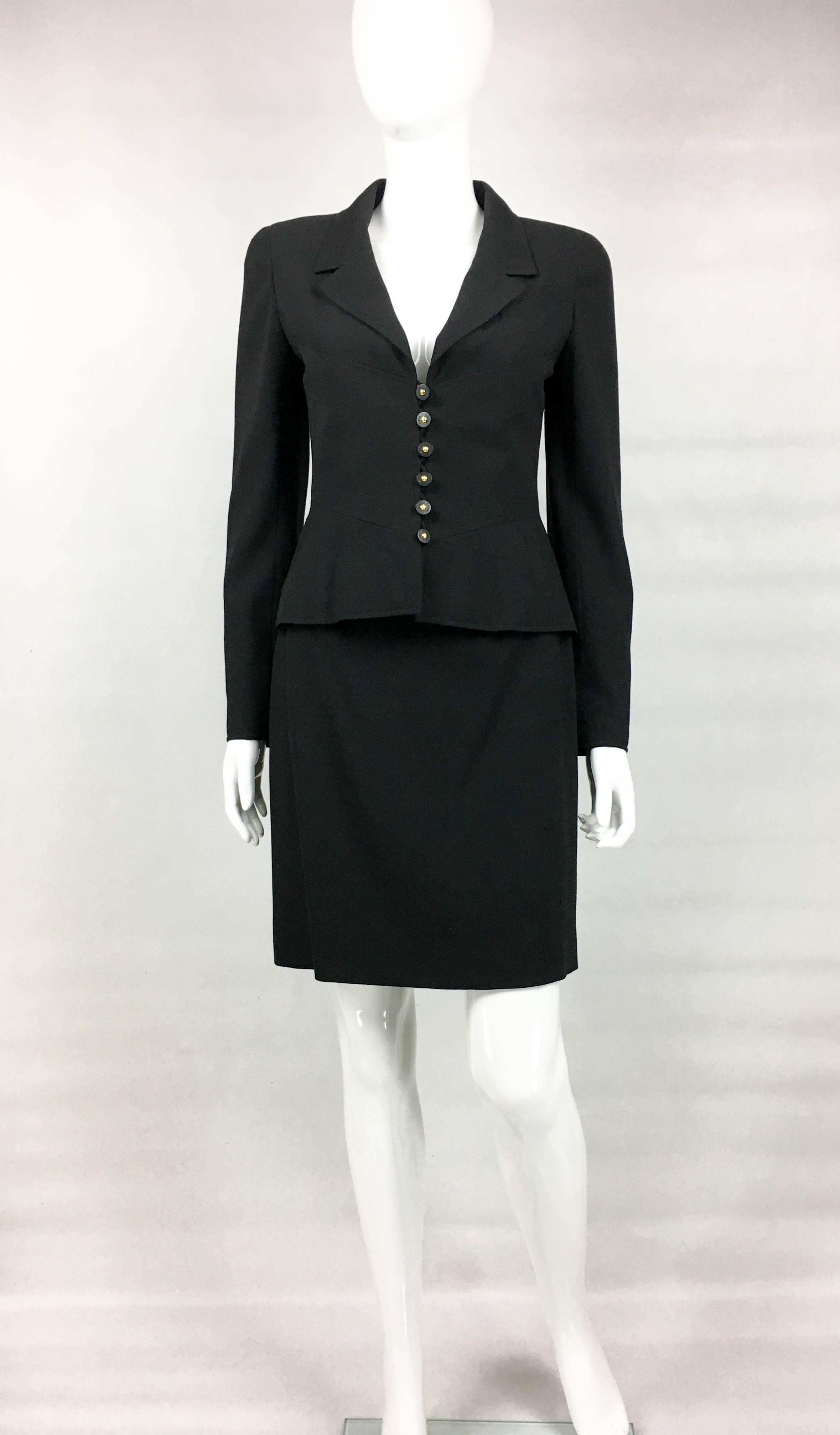 Vintage Chanel Black Wool Skirt Suit. This stylish ensemble by Chanel was part of the 1997 Spring / Summer Collection. Made in black wool and lined in silk, the single-breasted jacket accentuates the waist slightly, and the just above the knee