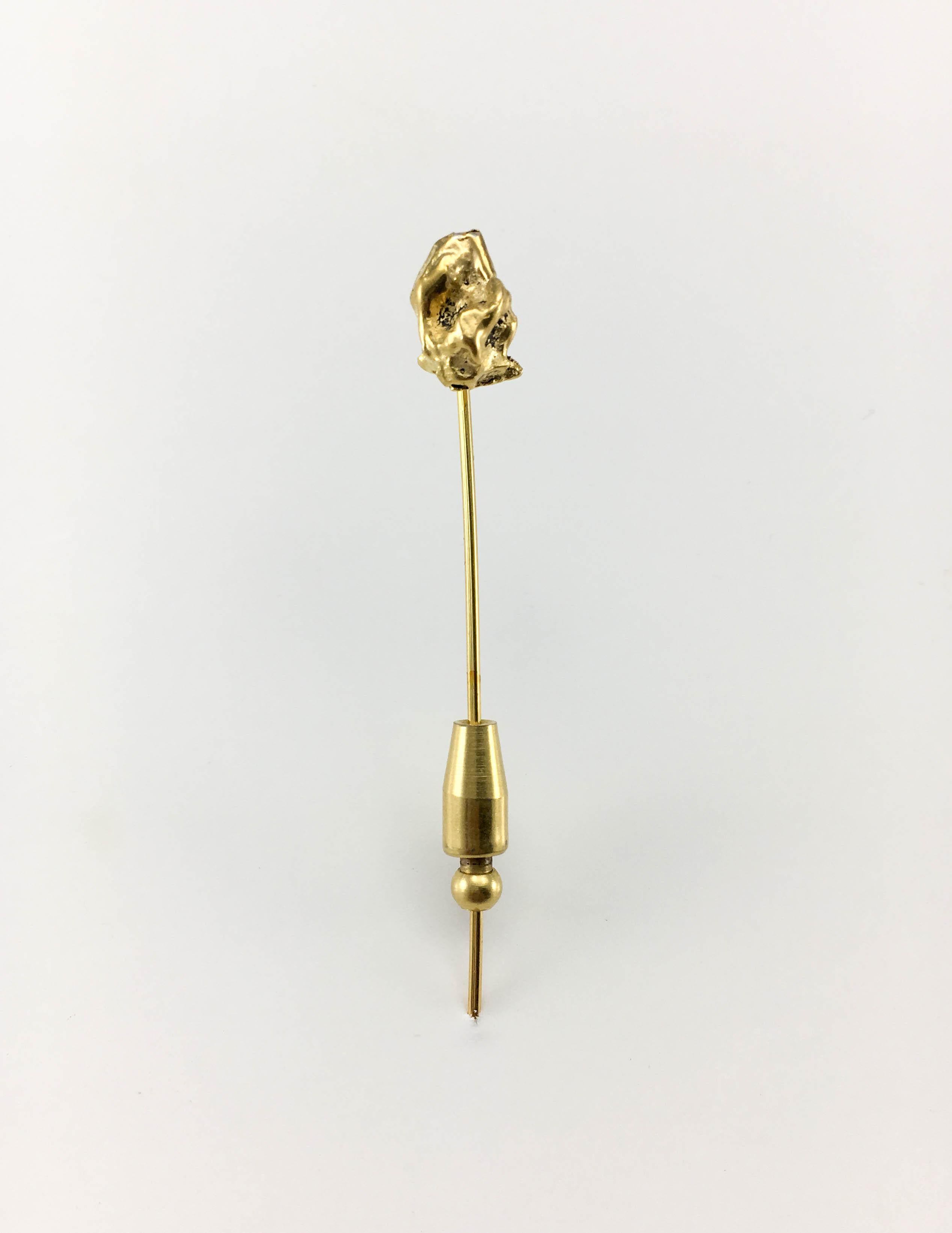 Vintage Chanel Gold-Plated Pin. This stylish pin by Chanel dates back from the 1970’s. Gold-plated, it was designed to resemble a gold nugget. Versatile, it can be worn on a hat, coat, scarf or even a tie. Chanel signed and number on the back – it
