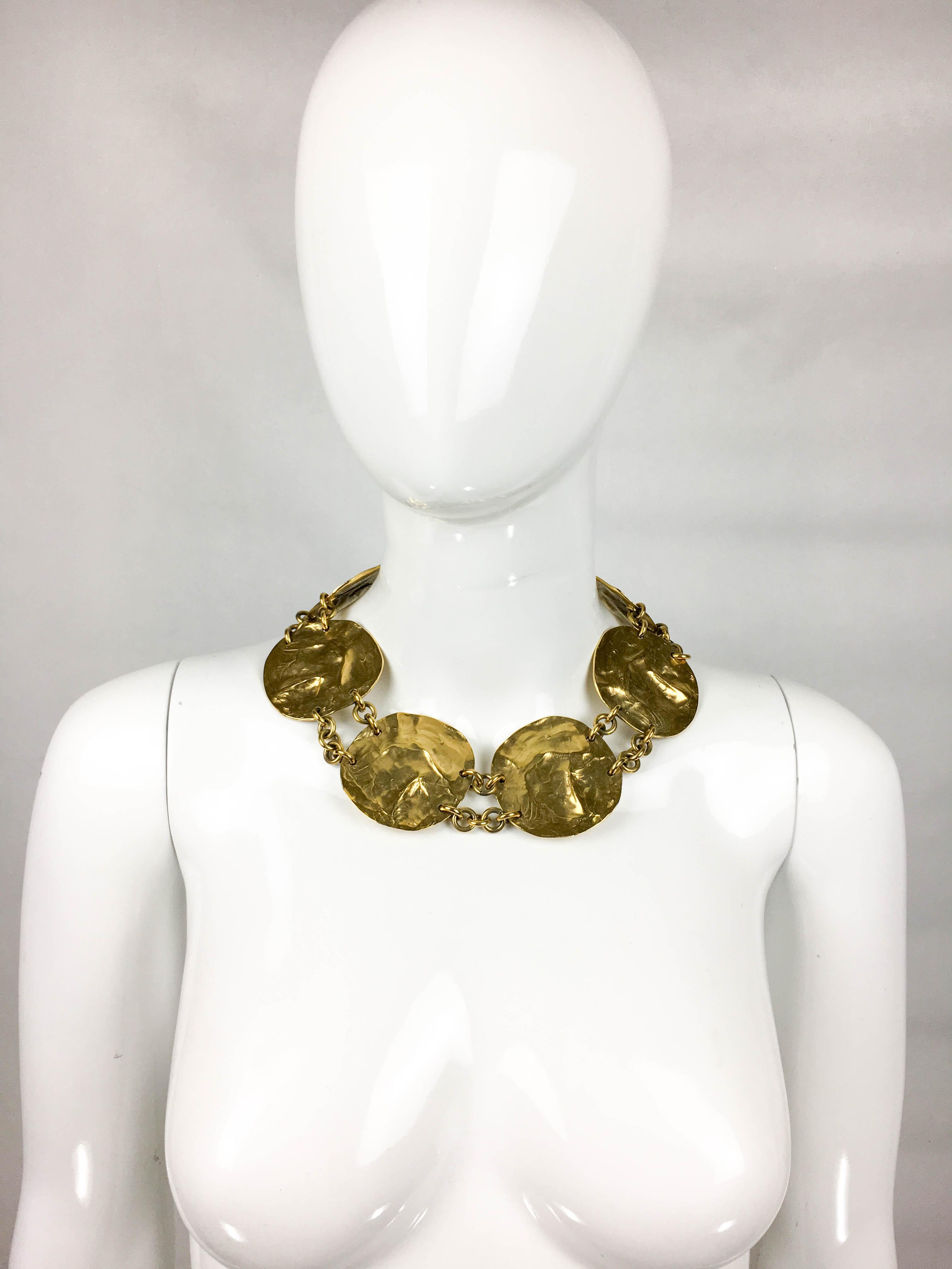 Vintage Yves Saint Laurent Gold-Plated Disk Necklace. This stunning piece by Yves Saint Laurent was created by Robert Goossens for the 1989 Spring / Summer Collection. Made in gold-plated metal, six disks with organic feel and look linked by chains.