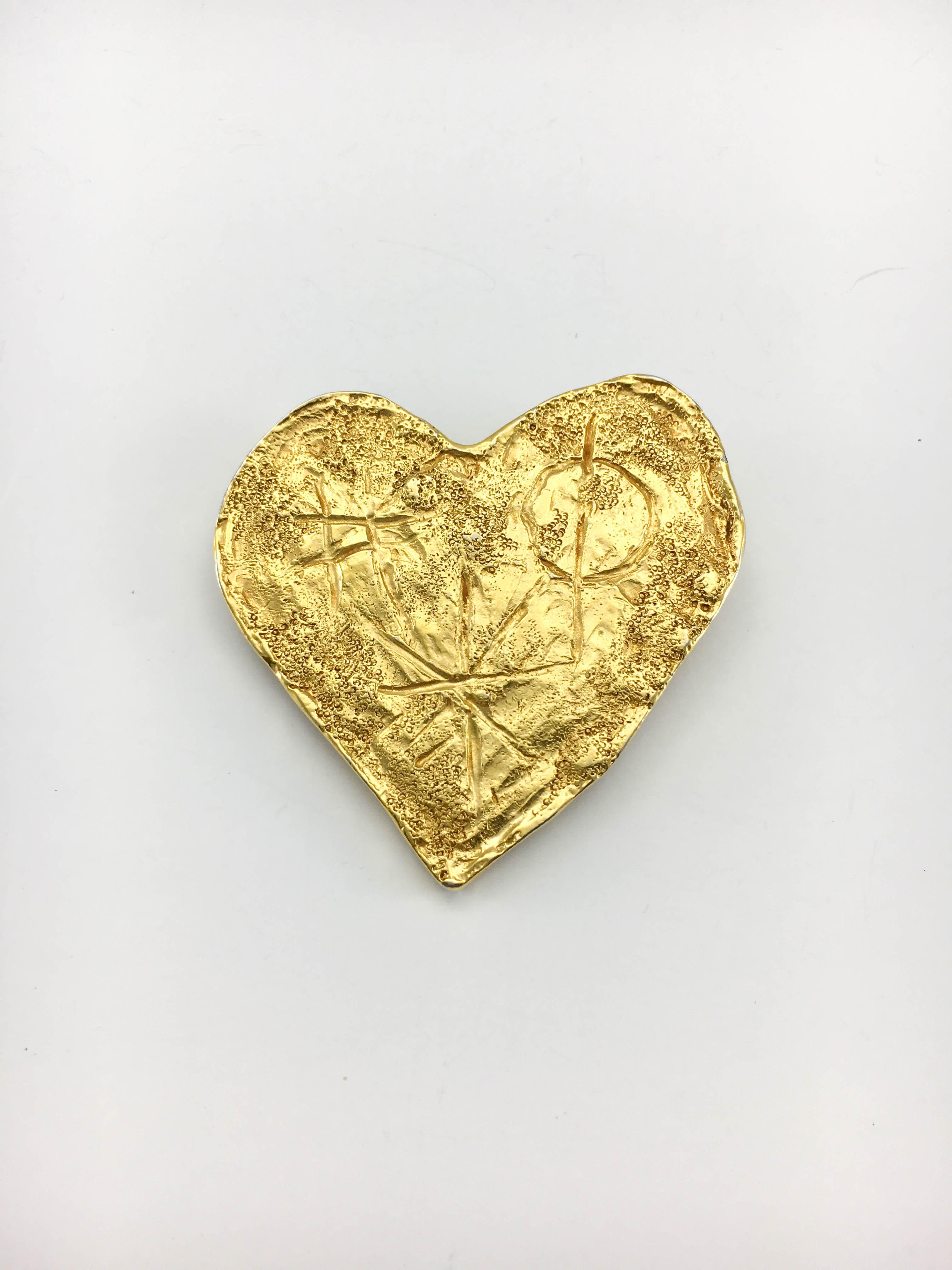 Vintage Christian Lacroix Gold-Plated Texturized Brooch. This striking brooch by Christian Lacroix by Goossens was created in 1994. Heart-shaped and crafted in gold-plated metal, this piece is texturized, giving it an organic, raw feel, and bears a