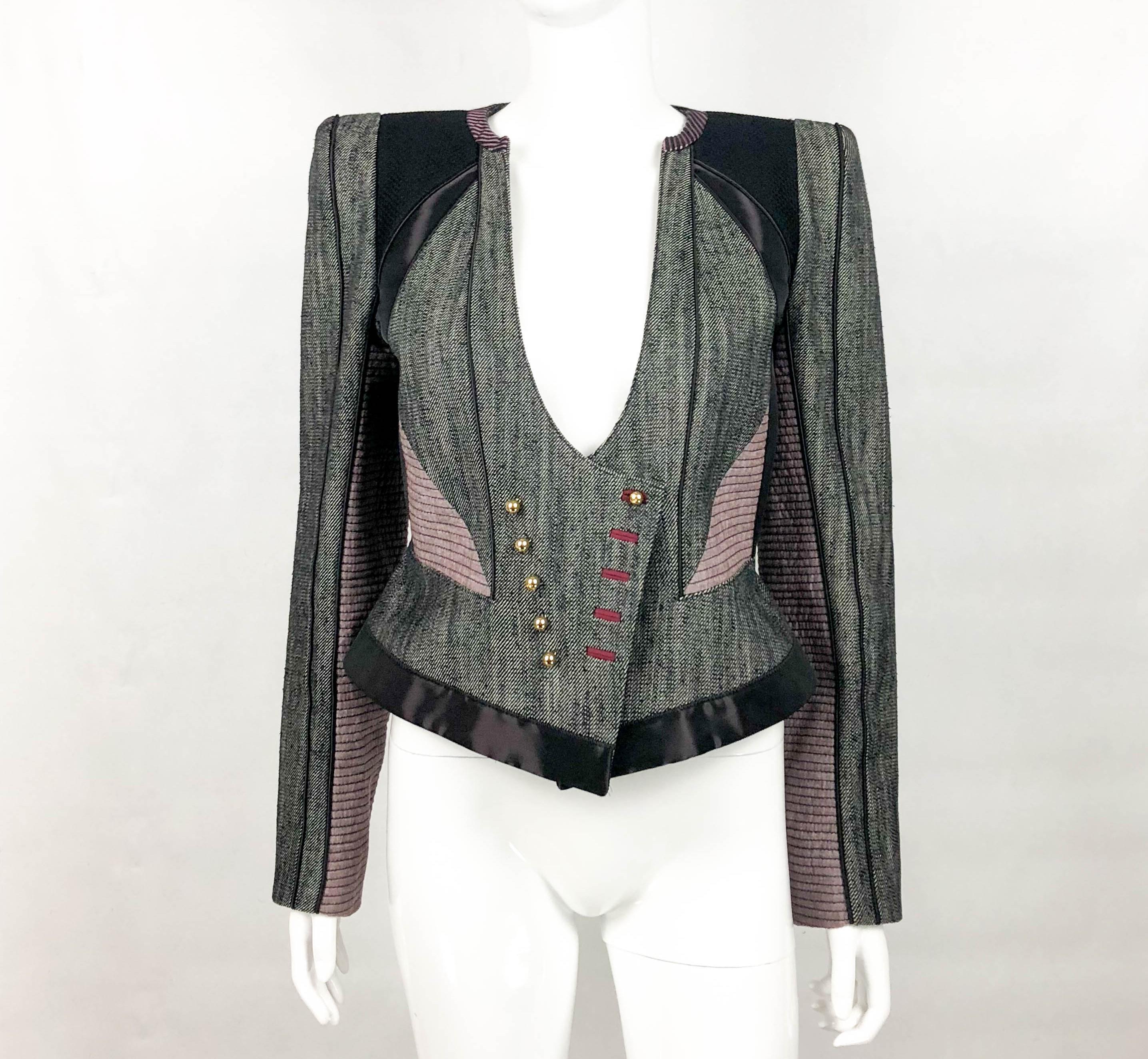 Louis Vuitton Futuristic Jacket. This striking jacket is from the Marc Jacobs’ era in Louis Vuitton. Of futuristic design, it made of panels of different textiles put together. The waist is accentuated, and the shoulders are structured. There are 10