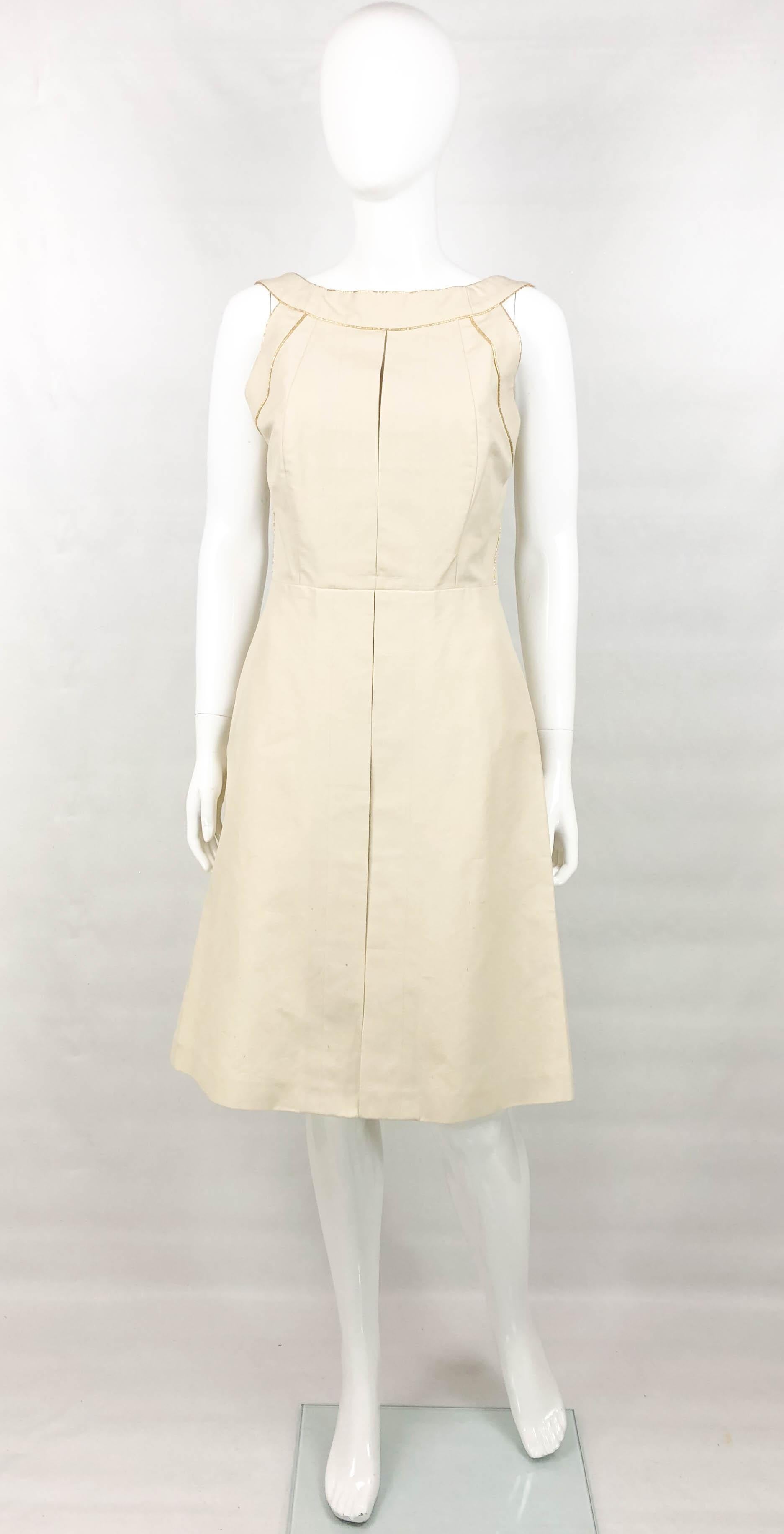 Yves Saint Laurent Cream Cotton Dress. This stylish dress by Yves Saint Laurent was created for the 2011 Spring / Summer Collection. Made in cream cotton, this sleeveless dress hovers at knee height and has accentuated waist. The top half of the