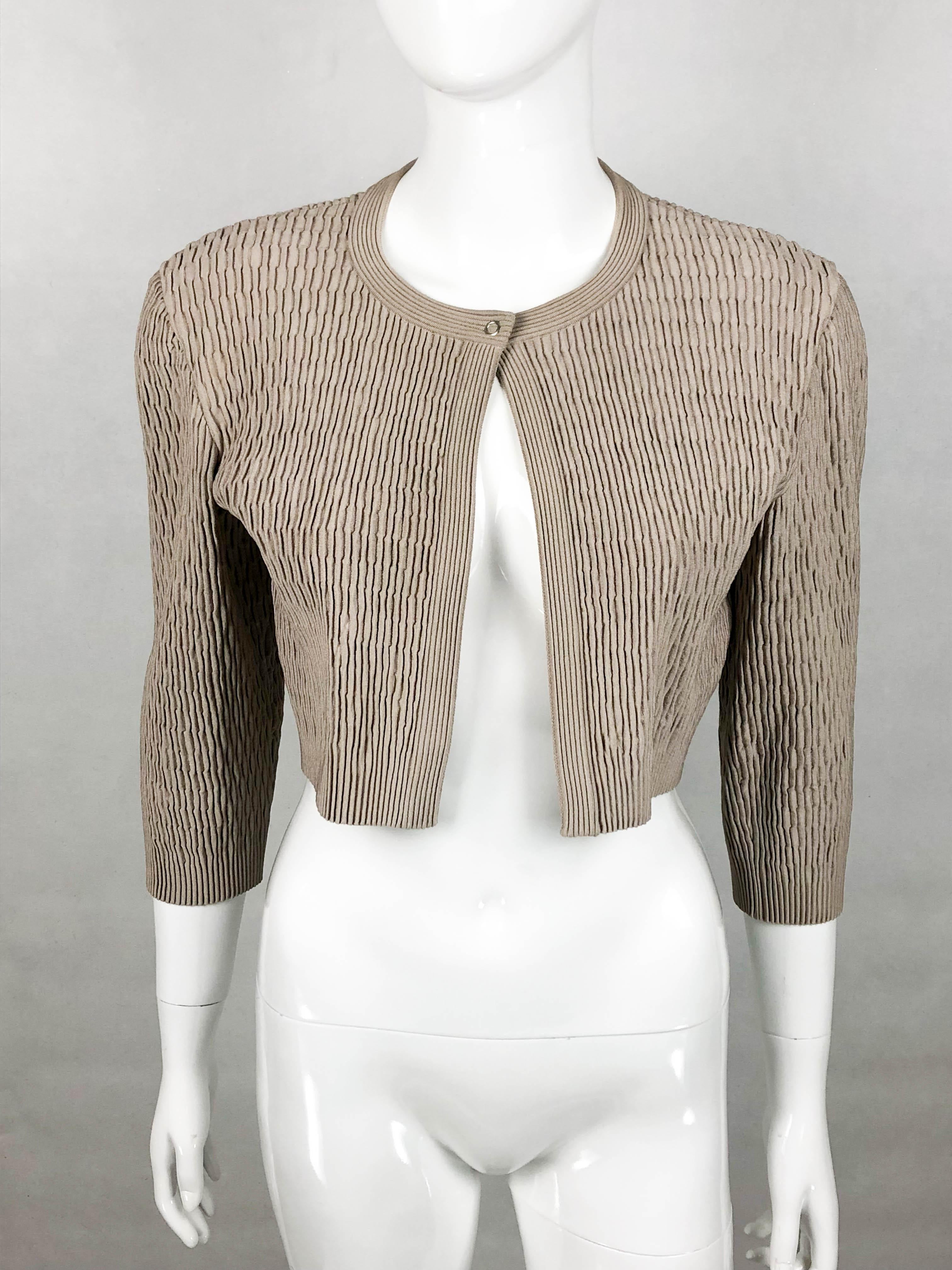 Vintage Alaia Taupe Stretch Jacket. This very cute jacket by Azzedine Alaia dates back from the early 2000’s. This cropped jacket of gathered design features ¾ sleeves and a pressure button at the collar. Flattering and versatile, this is the