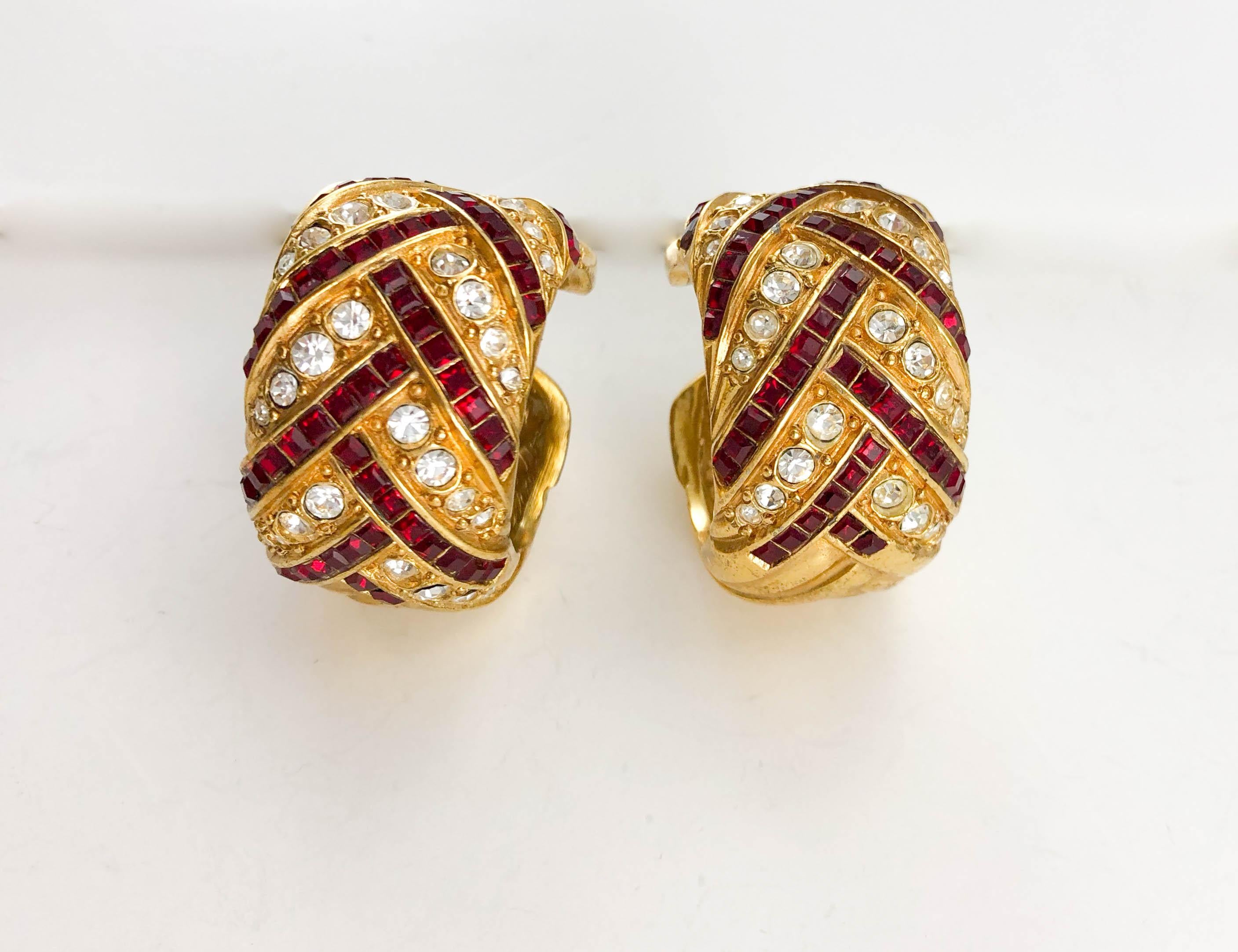 Vintage Yves Saint Laurent Crystal Embellished Clip-on Hoop Earrings. These gorgeous earrings by Yves Saint Laurent date back from the 1980’s. Made in gold-plated metal, they are adorned with round clear rhinestones and deep red square rhinestones.