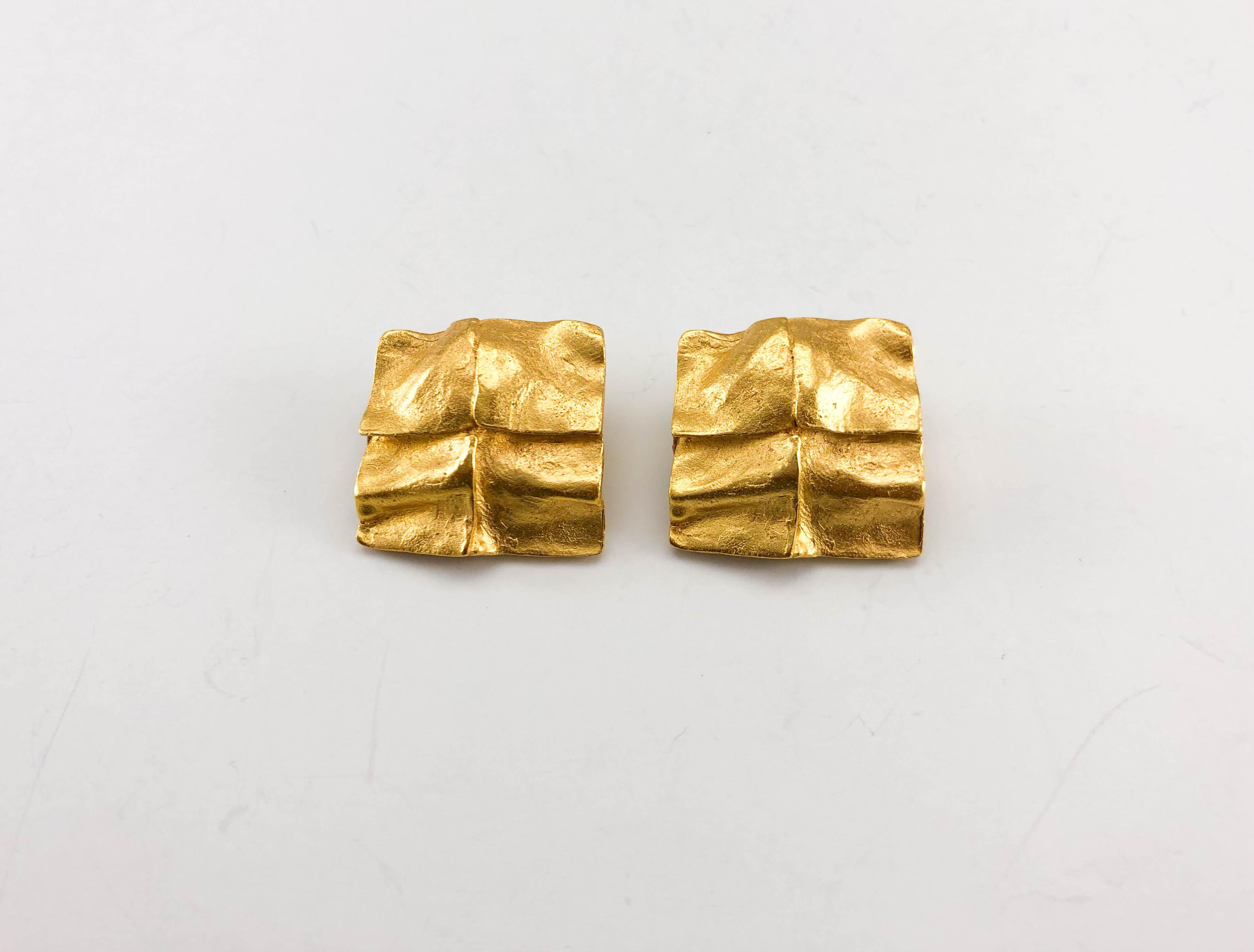 Vintage Yves Saint Laurent Gold-Plated Square Clip-on Earrings. These beautiful earrings by Yves Saint Laurent were created by Robert Goossens in the 1980’s. Made in gold-plated metal, the design resembles molten gold. YSL signed on the back. An