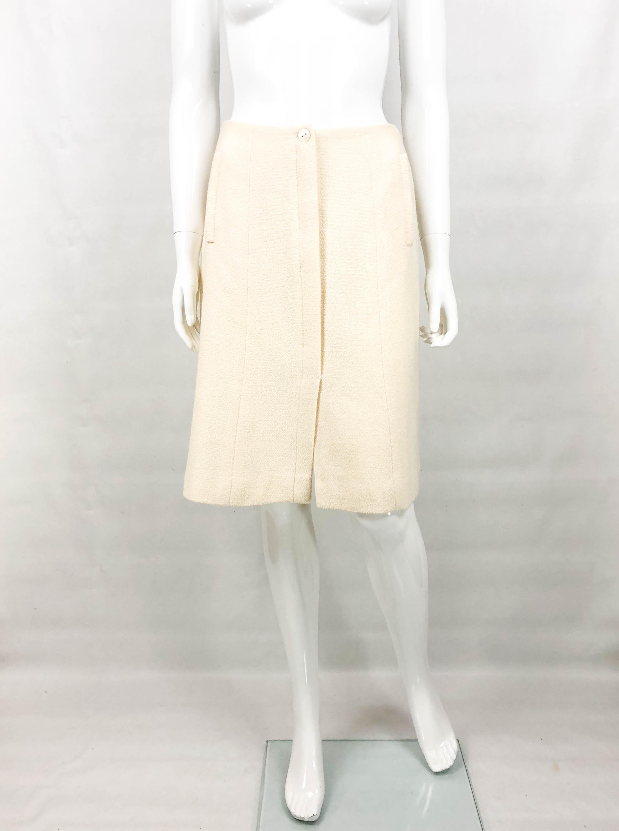 Chanel Vintage Cream Wool Skirt. This stylish skirt by Chanel is part of the 2003 Cruise collection. It is made in cream wool and it is lined in silk. A-line in shape, it hovers at knee height. It features a mother of pearl button saying Chanel