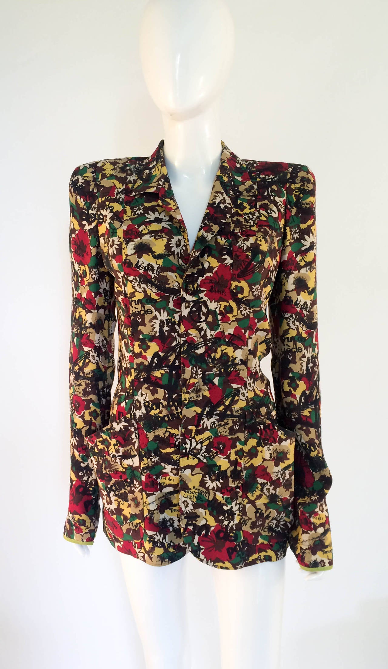 Rare Vintage Jean Paul Gaultier Jacket. Bold print with flowers and graffiti. Sharp tailoring with shoulder pads. 2 side pockets and 1 chest pocket. Pressure buttons covered in the same fabric. This is edgy jacket would make any outfit standout.