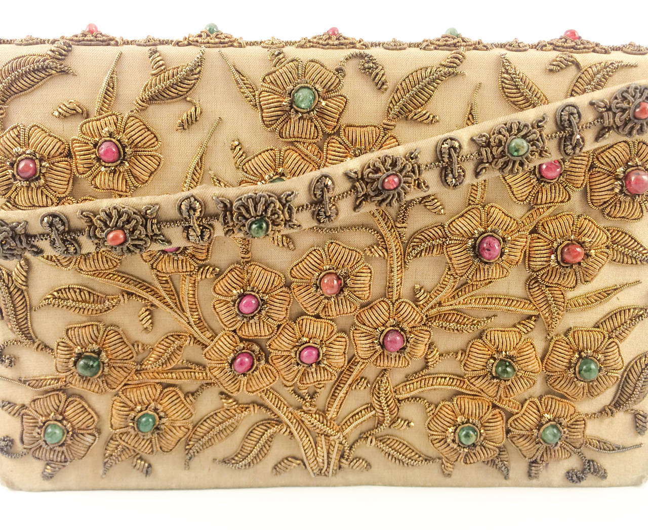 Absolutely stunning Vintage Jewelled Handbag. This clutch is decorated with gild silver, emeralds and rubies.  The flowers and leaves are crafted using the gild silver wires, and the emeralds and rubies are placed in the middle of the flowers. The
