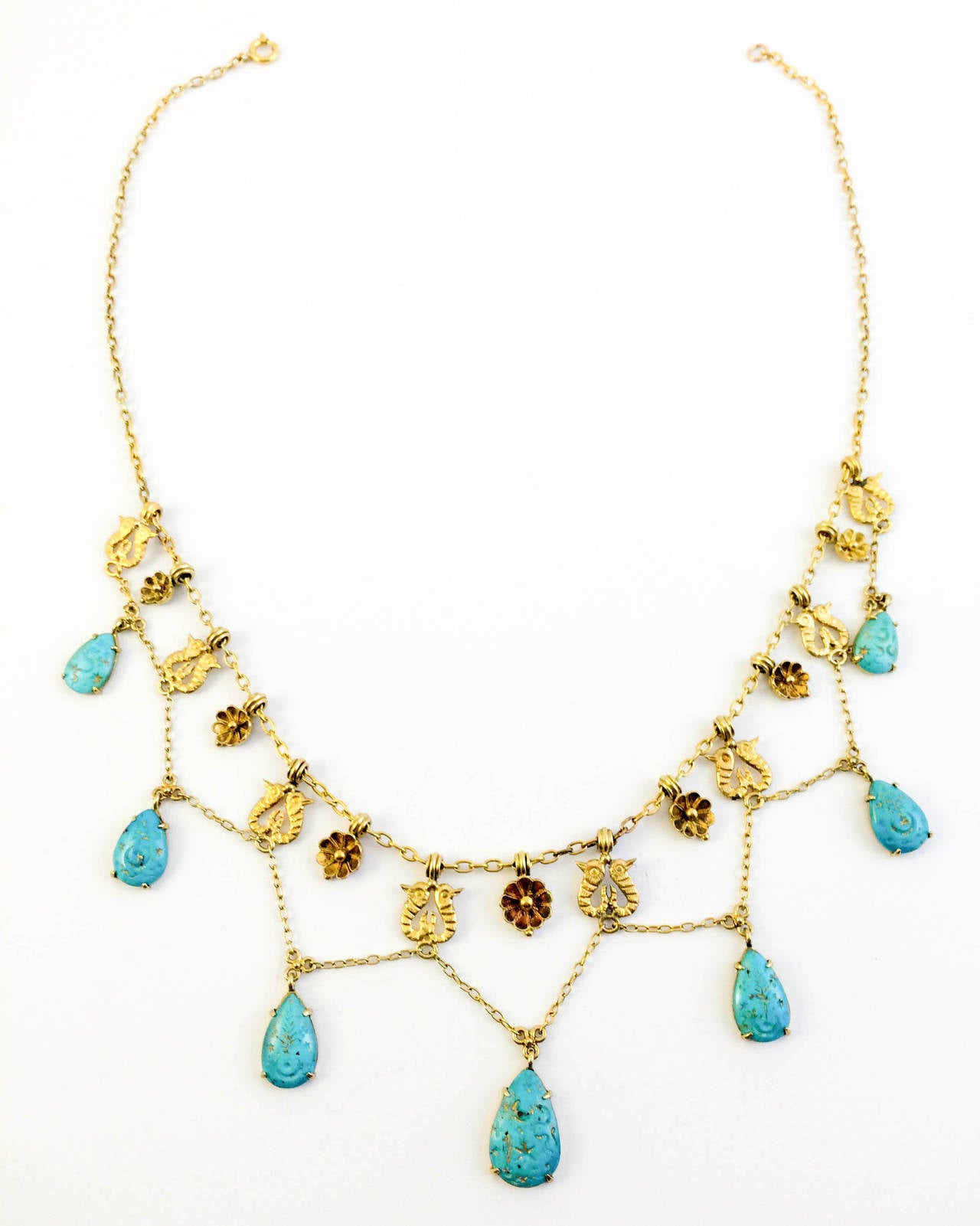 Gorgeous antique Turquoise and Gold Necklace. Egyptian revival motif. Beautiful carving on the turquoise beads. Gold has been worked to great deal of detail. Show-stopper necklace.

Period: 1920s

Origin: France

Style: Egyptian