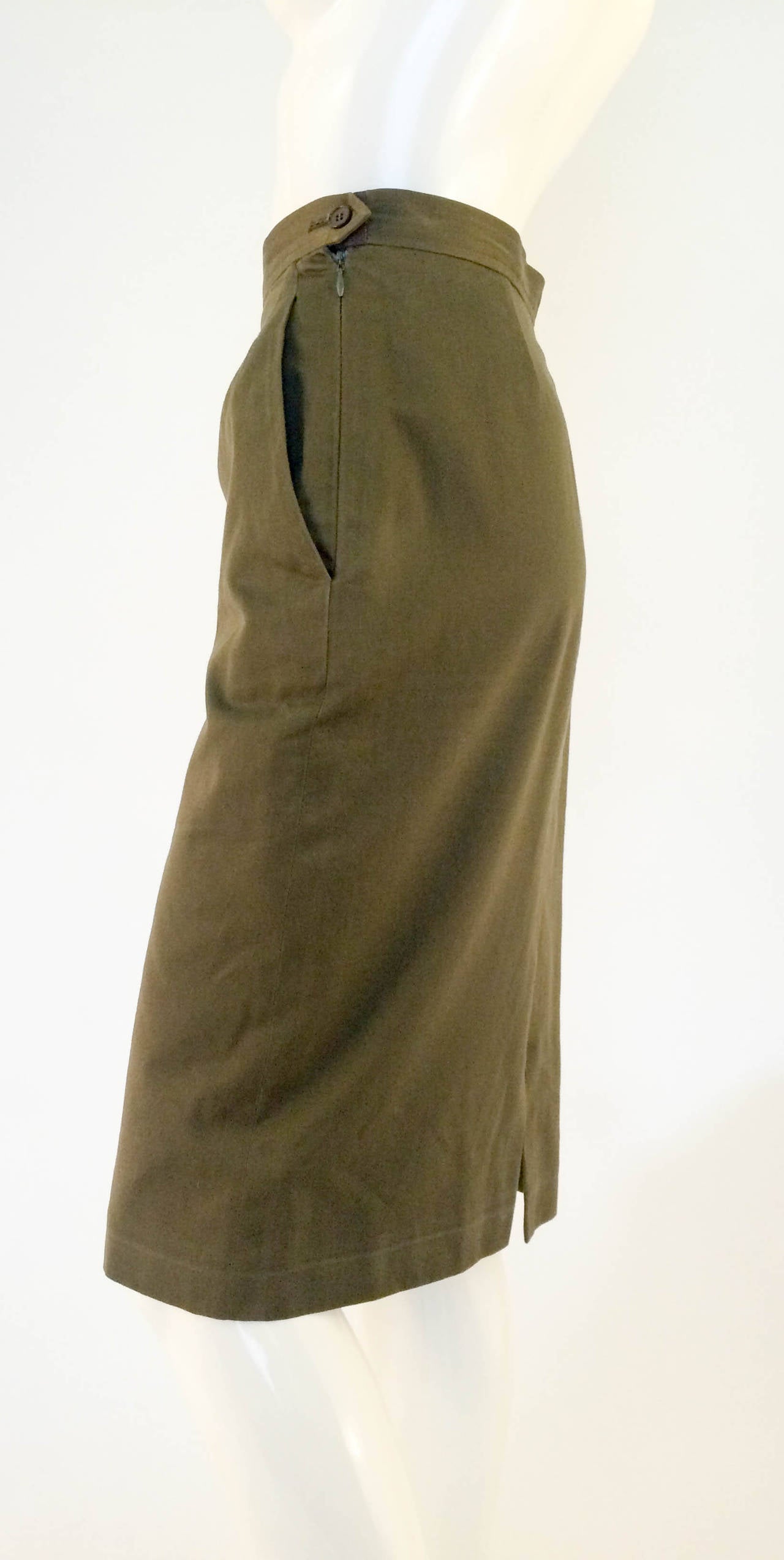 Stylish and Practical Yves Saint Laurent Rive Gauche Cotton Skirt. Late 80's, maybe early 90s. Military green cotton. Side pockets. The cut is straight down from the hips. Iconic and functional design. Made in France. Dry cleaned.

Condition: