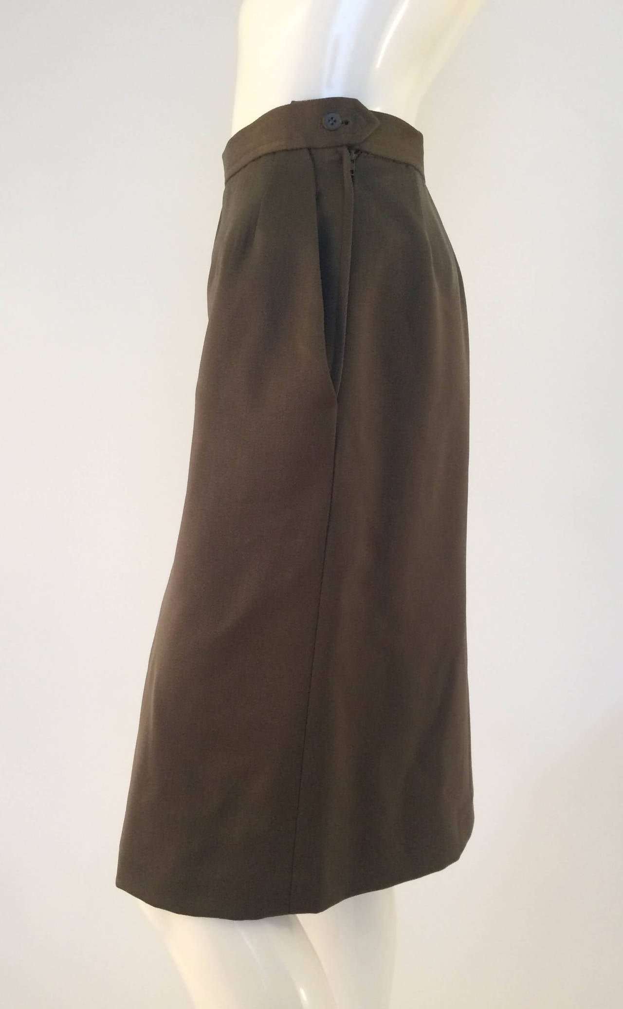 Very Elegant Yves Saint Laurent Rive Gauche Skirt. Most certainly late 1980s, but maybe very early 1990s. 100% wool with lining, but not heavy. Dark / military green. Practical side pockets. The cut goes straight down to the hips. Made in France.