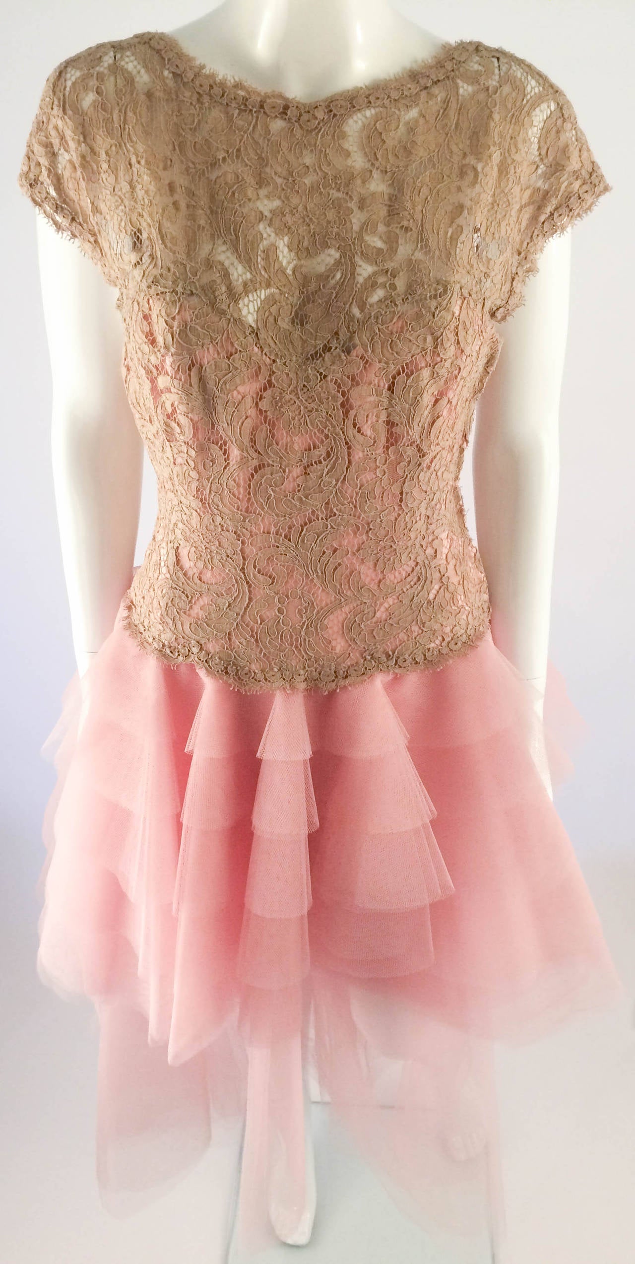 Absolutely stunning party dress. Beige lace corset with boning. Seven layers of pink tulle. The lining is in silk satin. This dress was custom made, so great attention to detail was paid to its construction. This piece is a classic example of Bruce