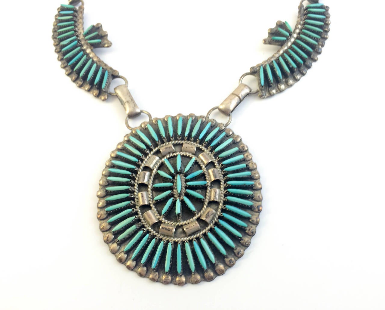 Stylish Native American Silver and Turquoise Necklace. The Zuni Native American design by Dewey & Janet Ghahate on silver features various needle point turquoise stones. This is beautiful and classic example of Native American jewelry.

