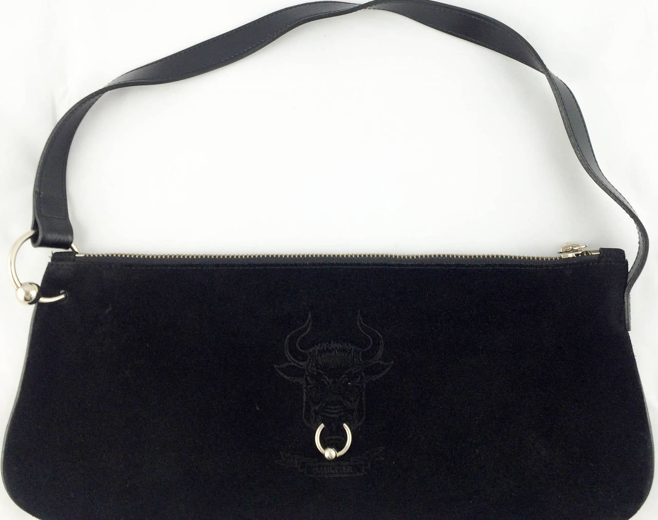 Funky Jean Paul Gaultier Bullring Handbag. This hip design by Jean Paul Gaultier is made in black velvet calfskin. The front of the bag shows a bull with a real bullring through the material, which is repeated in the zipper and one of the links to