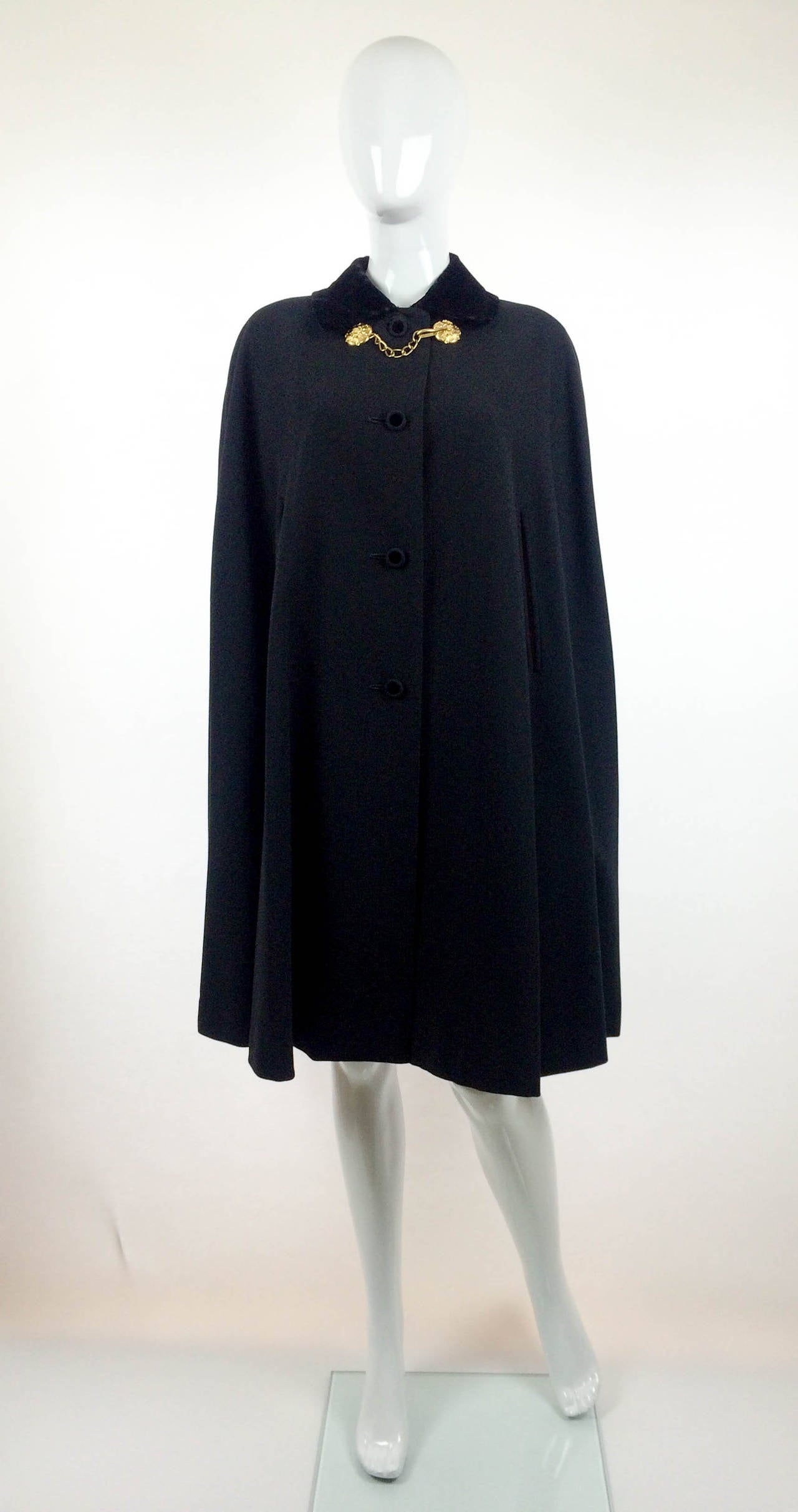 Stunning Vintage Rare Gieves Ltd Cape. The most accurate name for this beautiful piece is boat cloak. It is black, made of the finest wool with a velvet collar with openings/slits for the hands. There are 4 buttons down the front and an ornamental