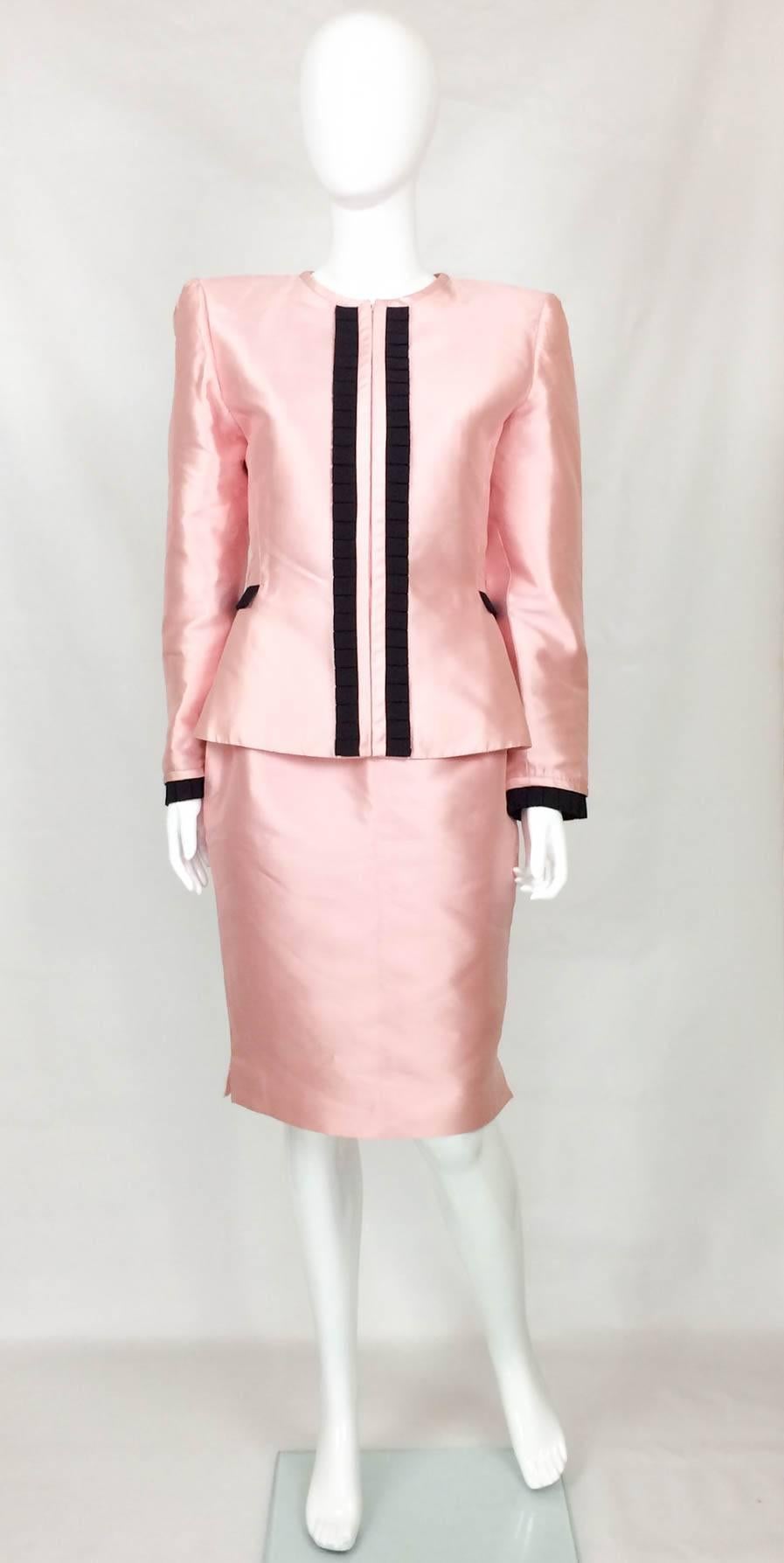 Elegant Valentino Silk Skirt Suit. This gorgeous ensemble in pastel pink pure silk features a black pleat trimming detail down the front, on the cuffs and across the waist on the back. The jacket has a defined waist, invisible zipper down the front